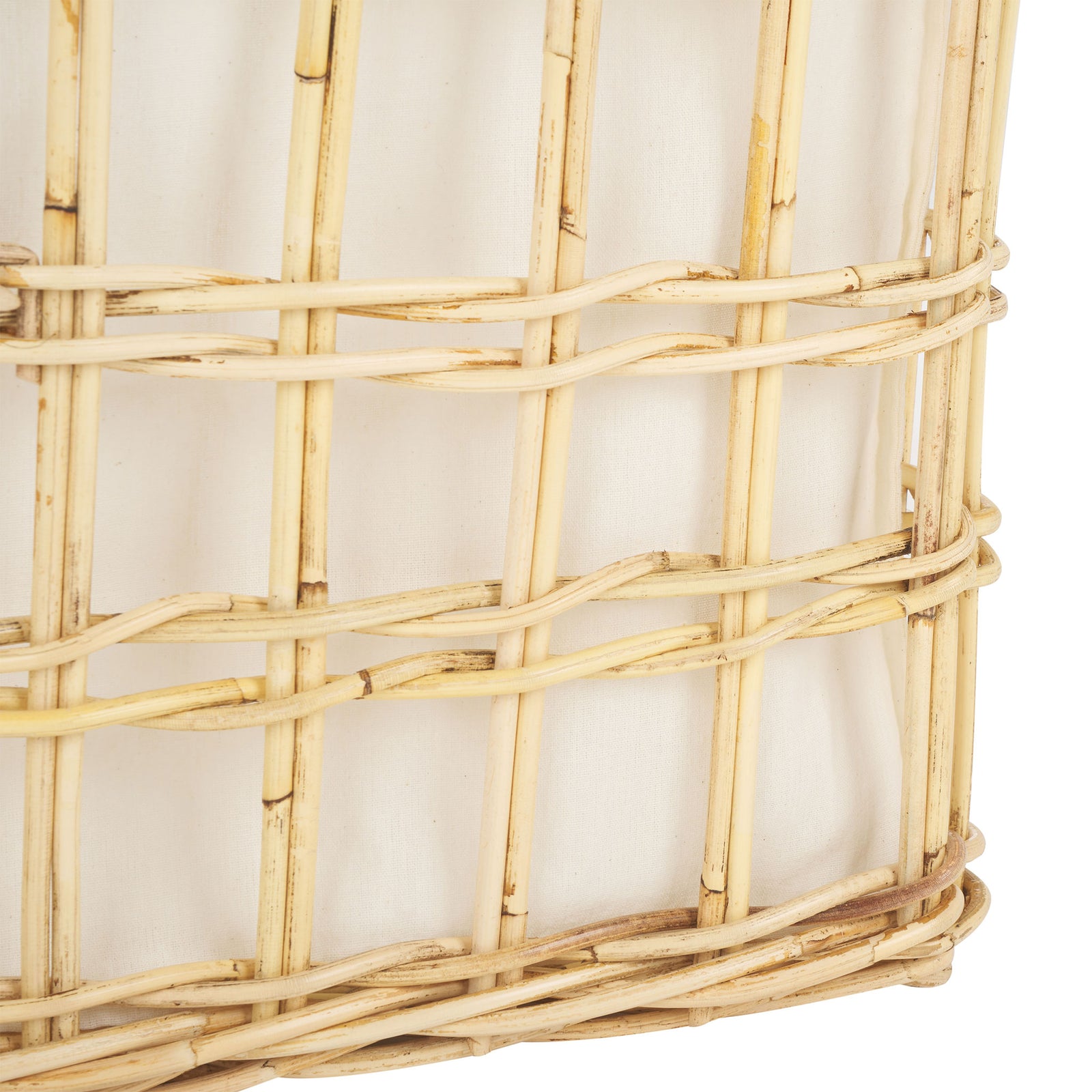 Woven rattan trim frames the lower edge of the basket against its soft white liner || STG6503A || detail_studio