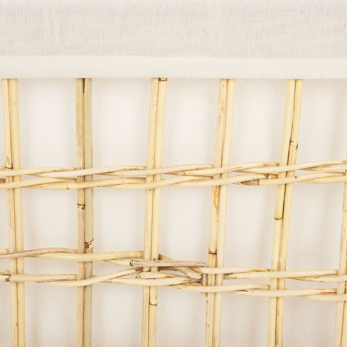 The basket's white cotton liner contrasts with the natural rattan grid and its textured weave || STG6503A || swatch_studio