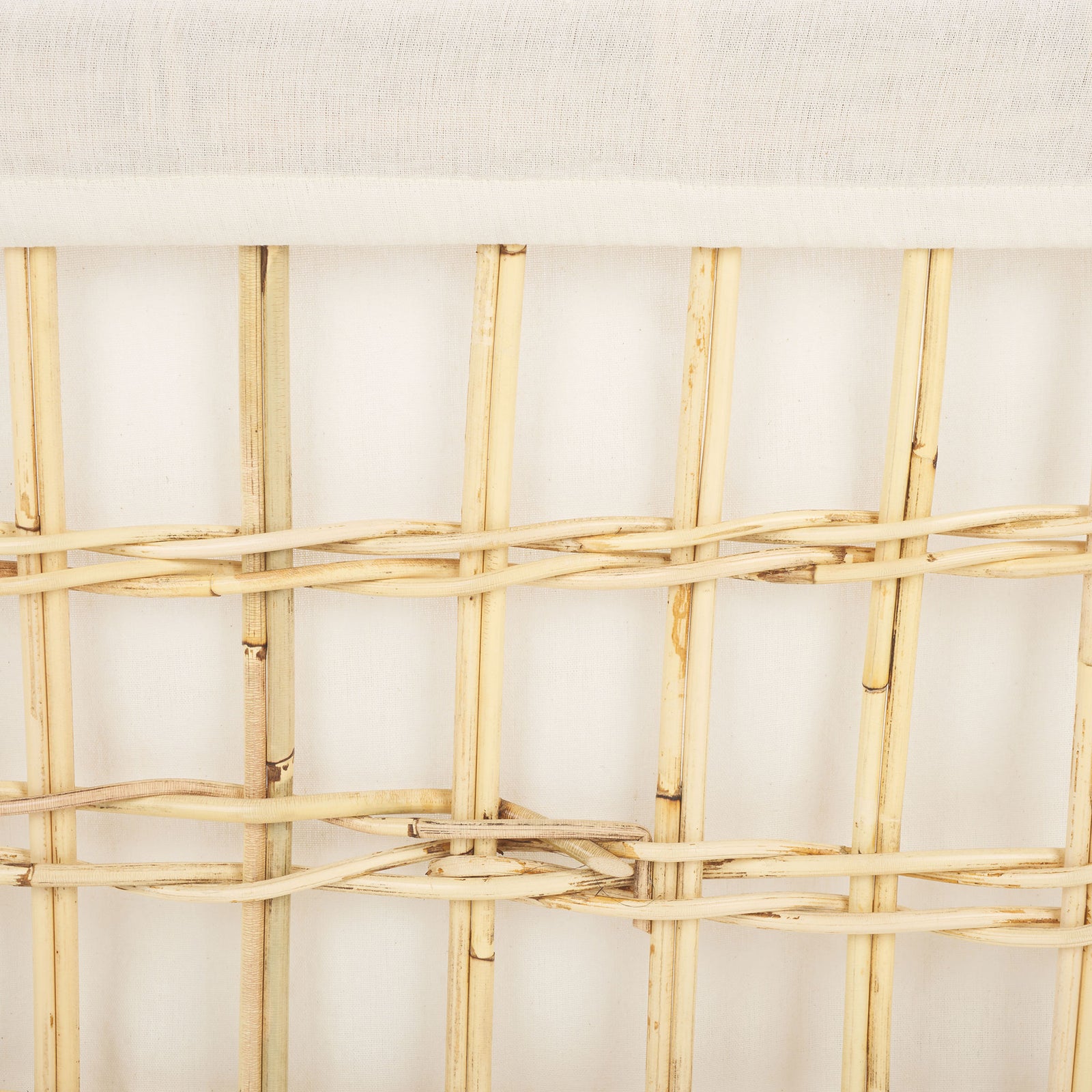 The basket's white cotton liner contrasts with the natural rattan grid and its textured weave || STG6503A || swatch_studio