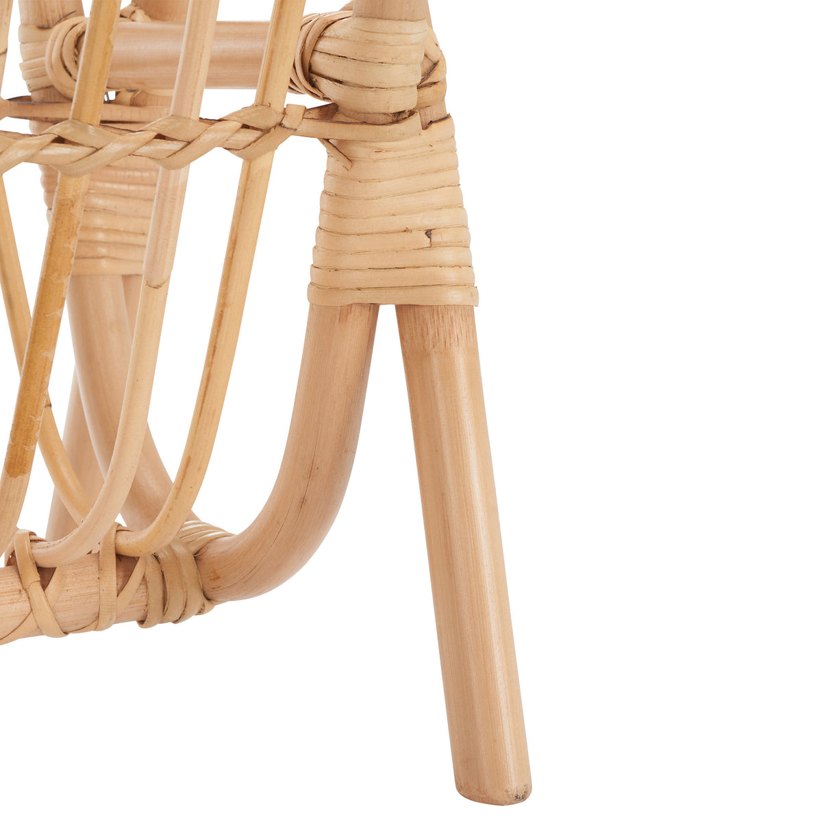 Splayed rattan legs and tightly wrapped joints give the magazine rack an organic look.