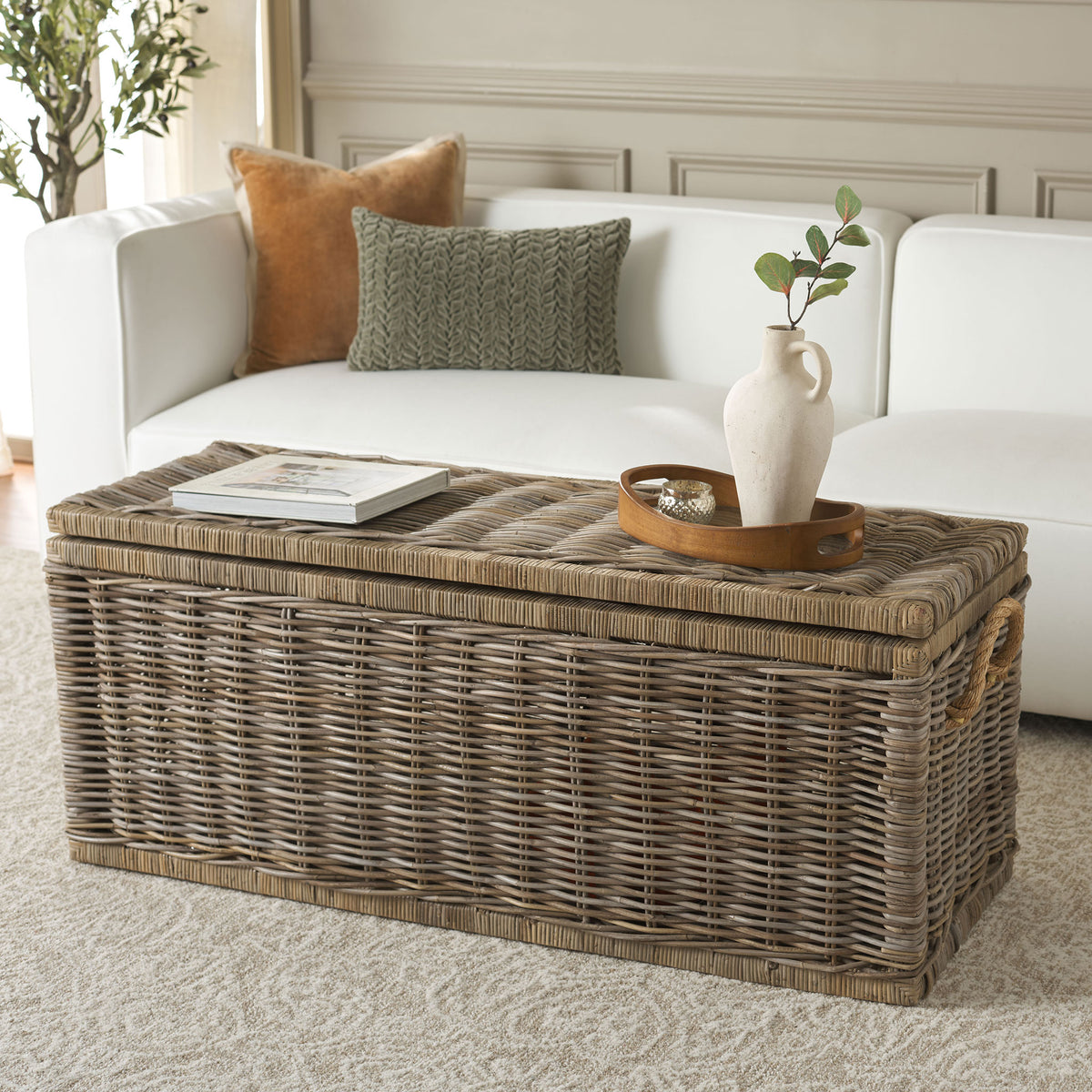 The flat woven lid holds books and decor while the rattan trunk keeps essentials tucked away. || STG6506A || front_angle_room