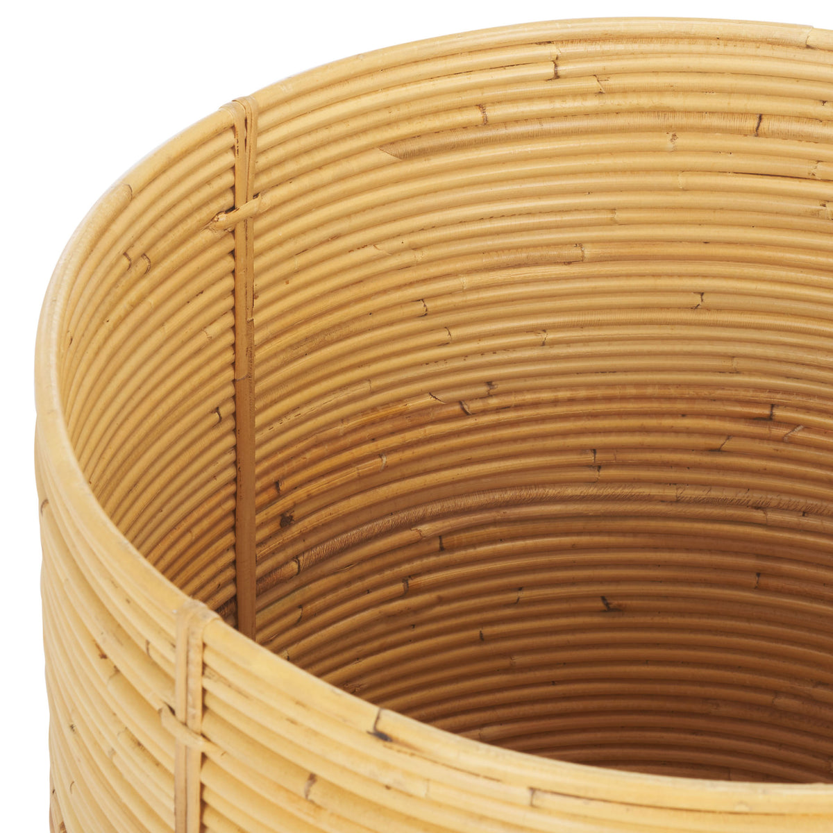 An open basket reveals rattan coils lining its roomy interior and a neatly bound rim. || STG6508A || storage_open_studio