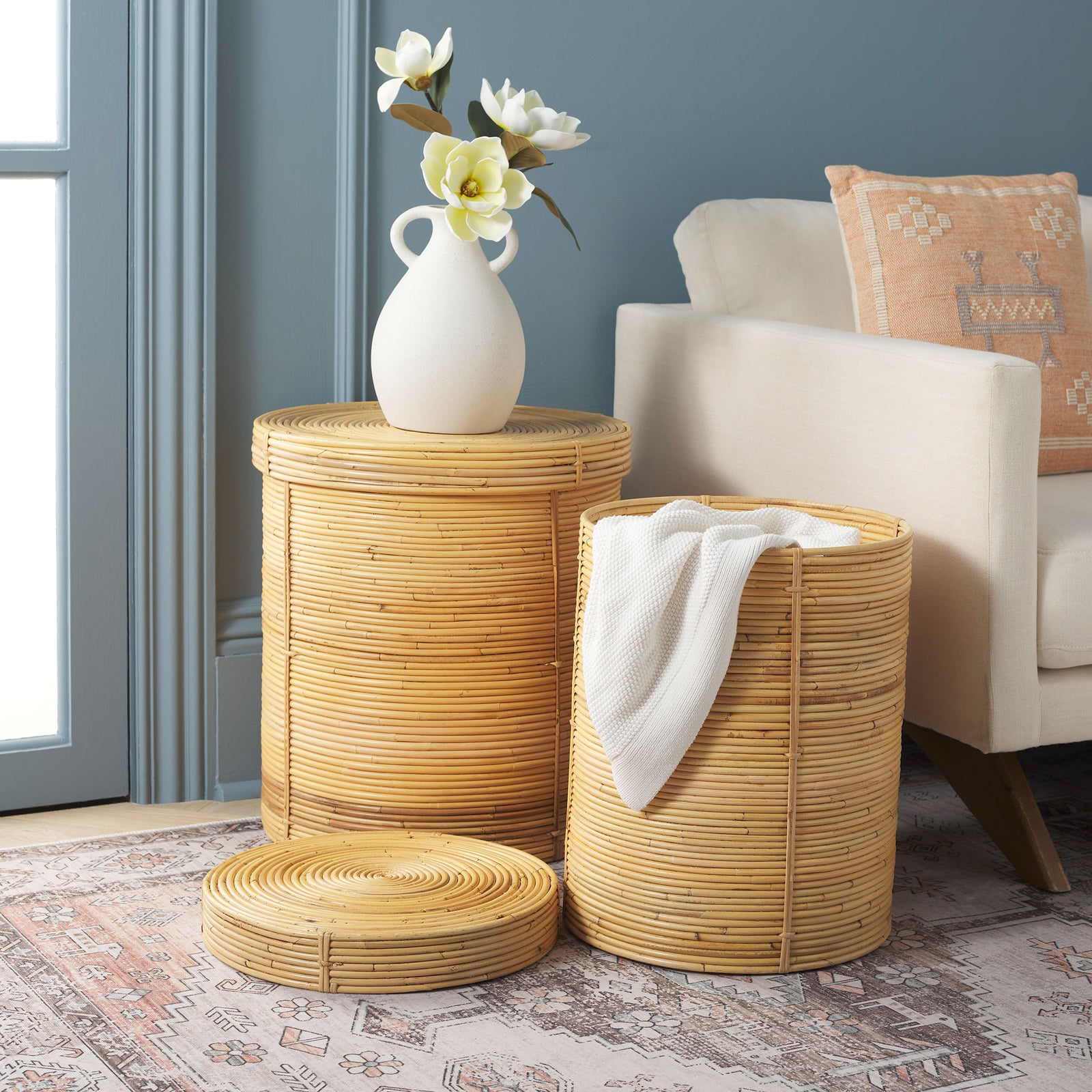 Natural rattan baskets offer flexible storage for throws and a lidded spot for decorative accents. || STG6508A || front_angle_open_room