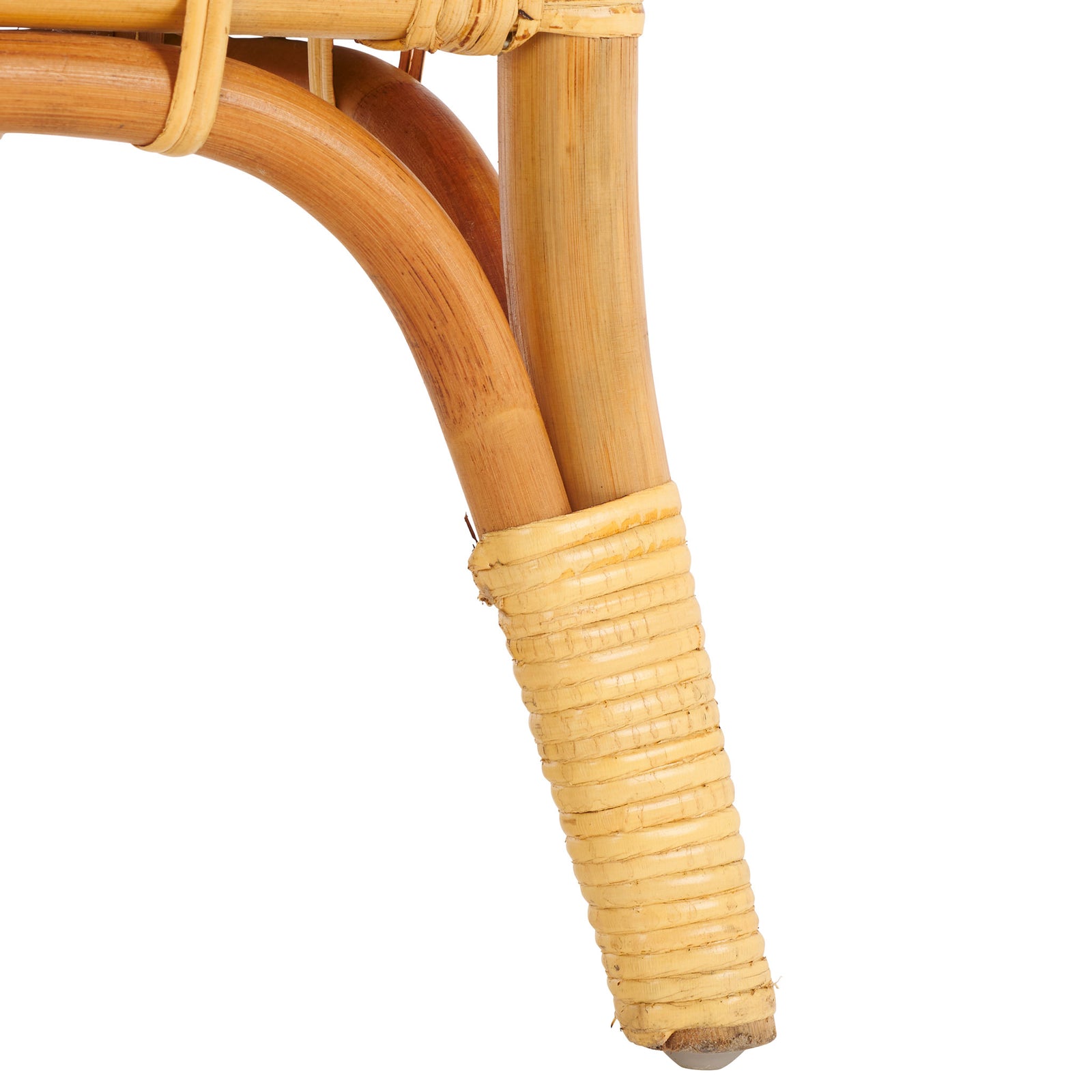 Warm natural rattan flares into a wrapped foot beneath a gently curved support || STG6509A || leg_studio