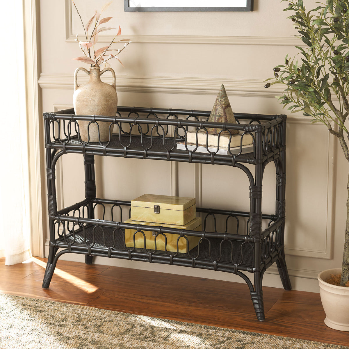 Black rattan console holds a ceramic vase and decorative accents above a roomy lower shelf || STG6509B || front_angle_room