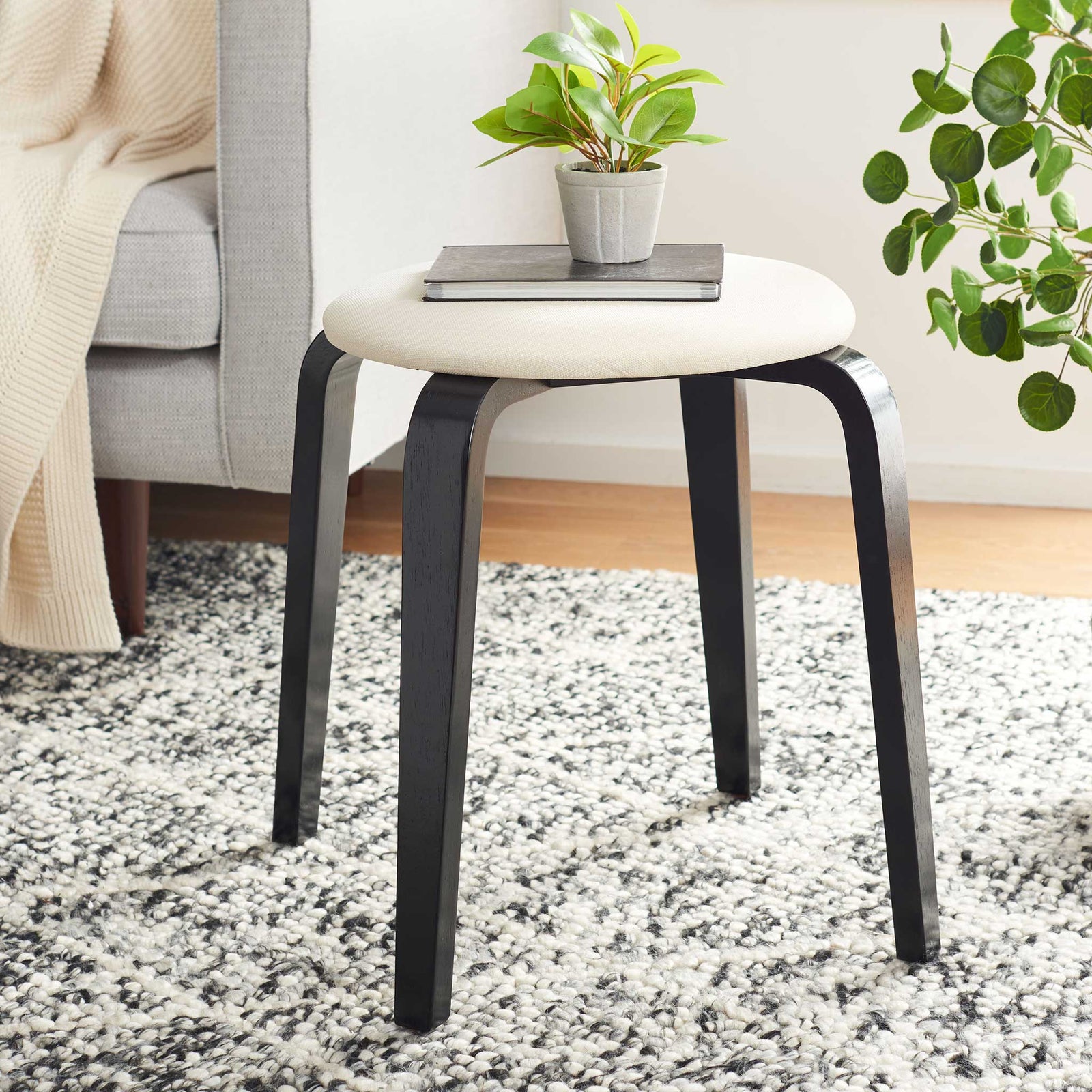 Versatile accent stool adds modern warmth with its cream seat and black wood legs || STL1001A || front_angle_room