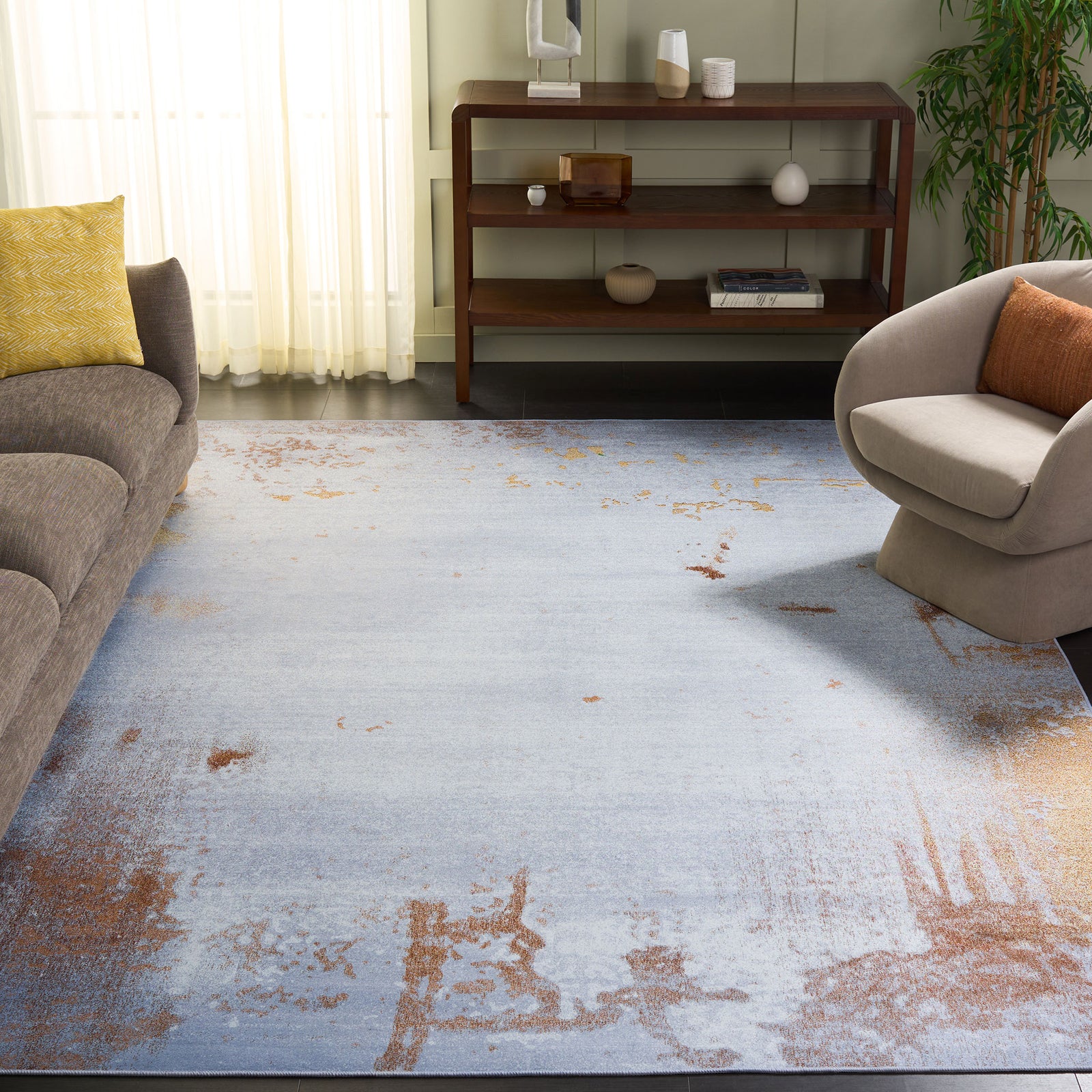 Modern abstract rug adds warm rust accents to a light gray room, pairing with contemporary decor || TAC802P-8 || front_angle_room