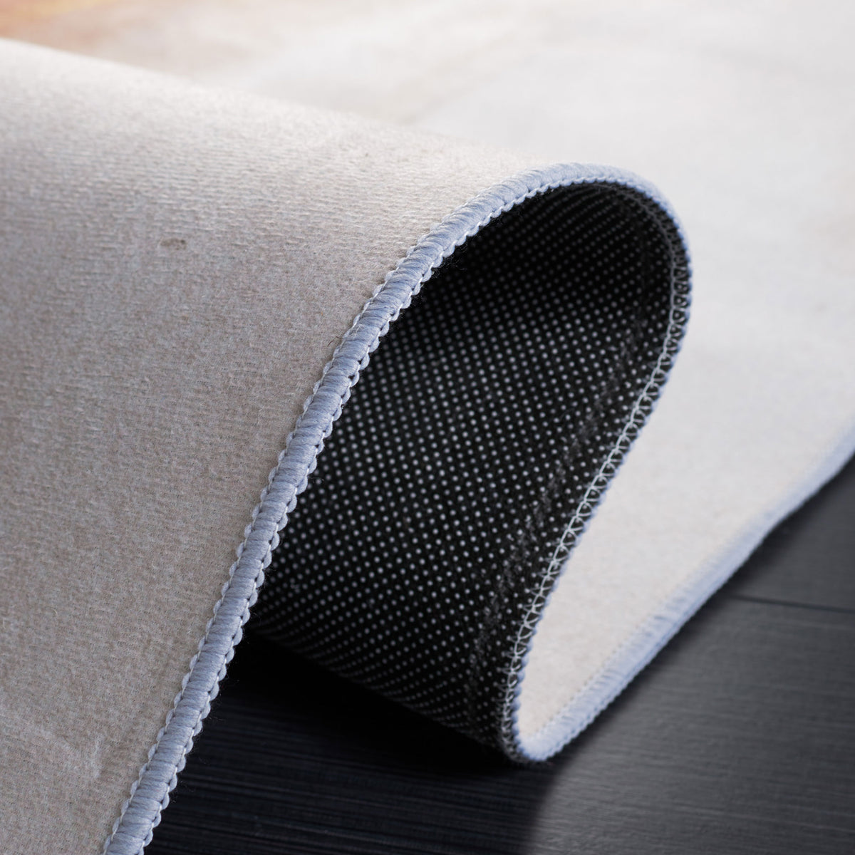 Non-slip dot backing shown with a folded corner for an easy view of the underside. || TAC807B-5 || backing_studio