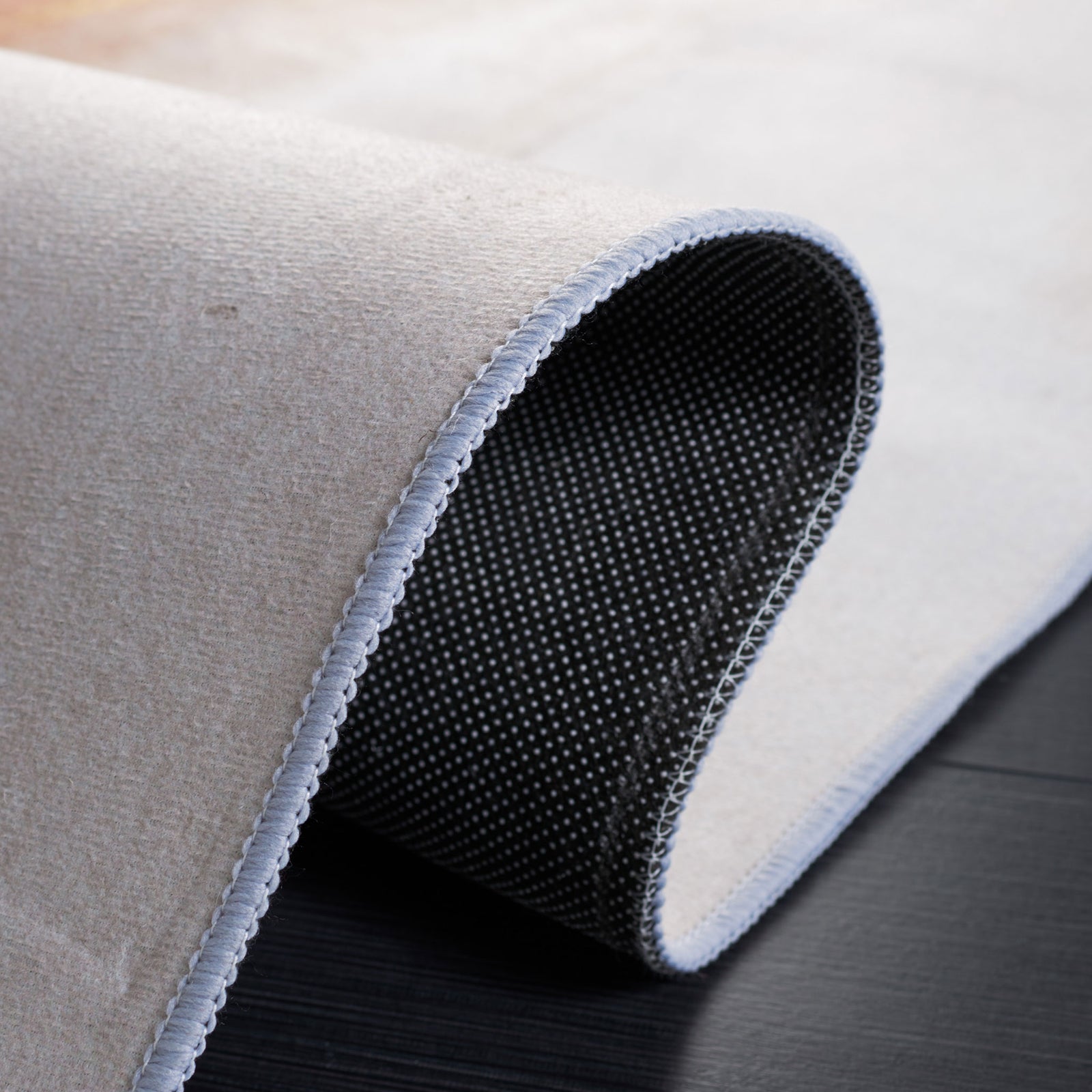 Non-slip dot backing shown with a folded corner for an easy view of the underside. || TAC807B-5 || backing_studio