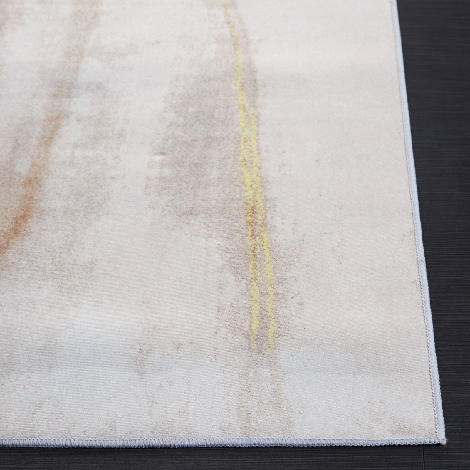 Abstract beige and gold rug with fluid painterly streaks on a soft, low-profile surface. || TAC807B-5 || top_studio