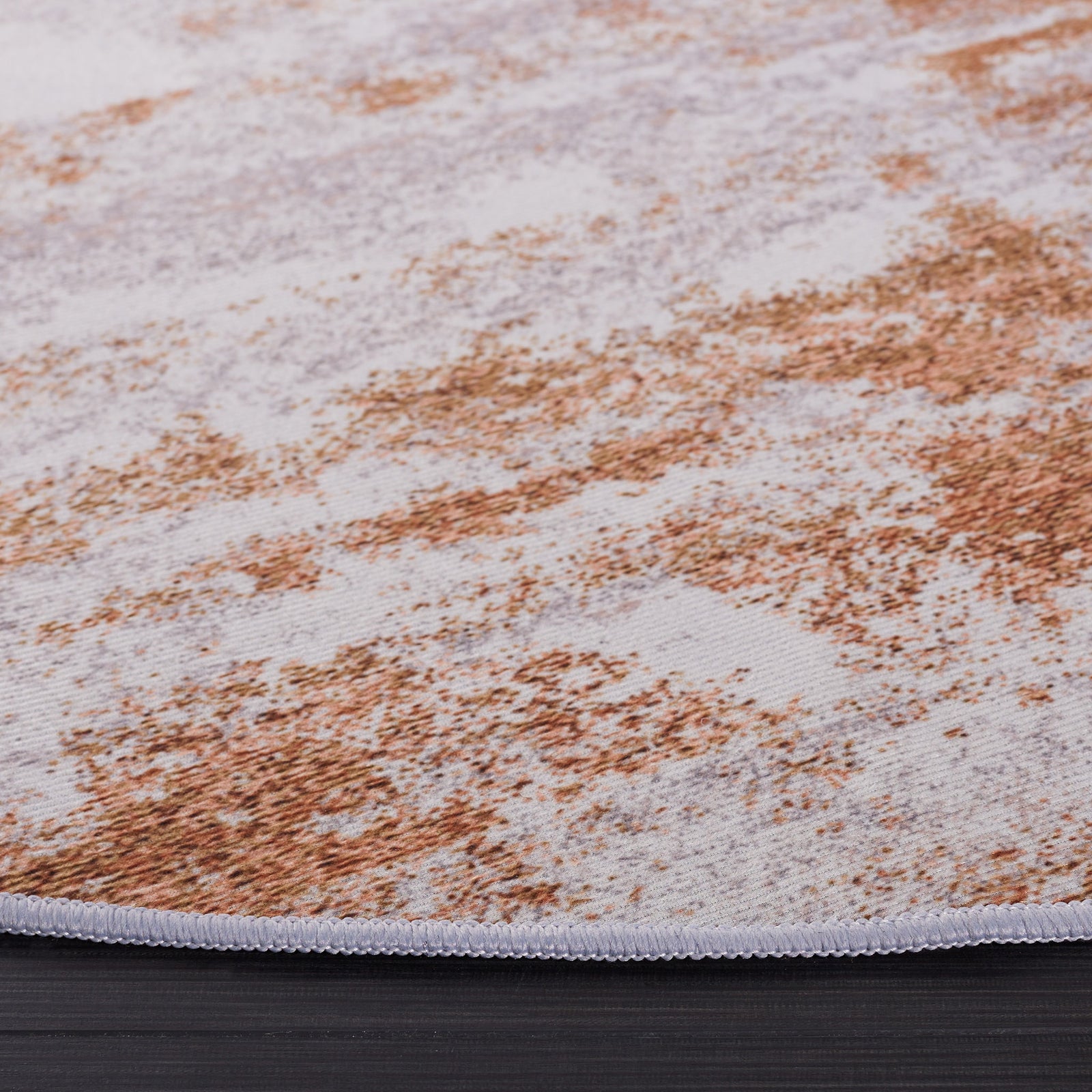 Subtle texture and stitched edge showcase the abstract gray and rust design with washable, non-slip ease. || TAC808P-6R || detail_studio