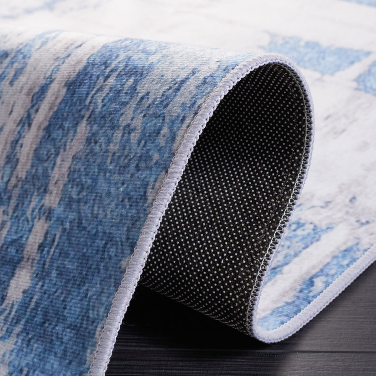 Curled edge reveals the dotted, slip-resistant backing and clean serged finish. || TAC812F-5 || backing_studio
