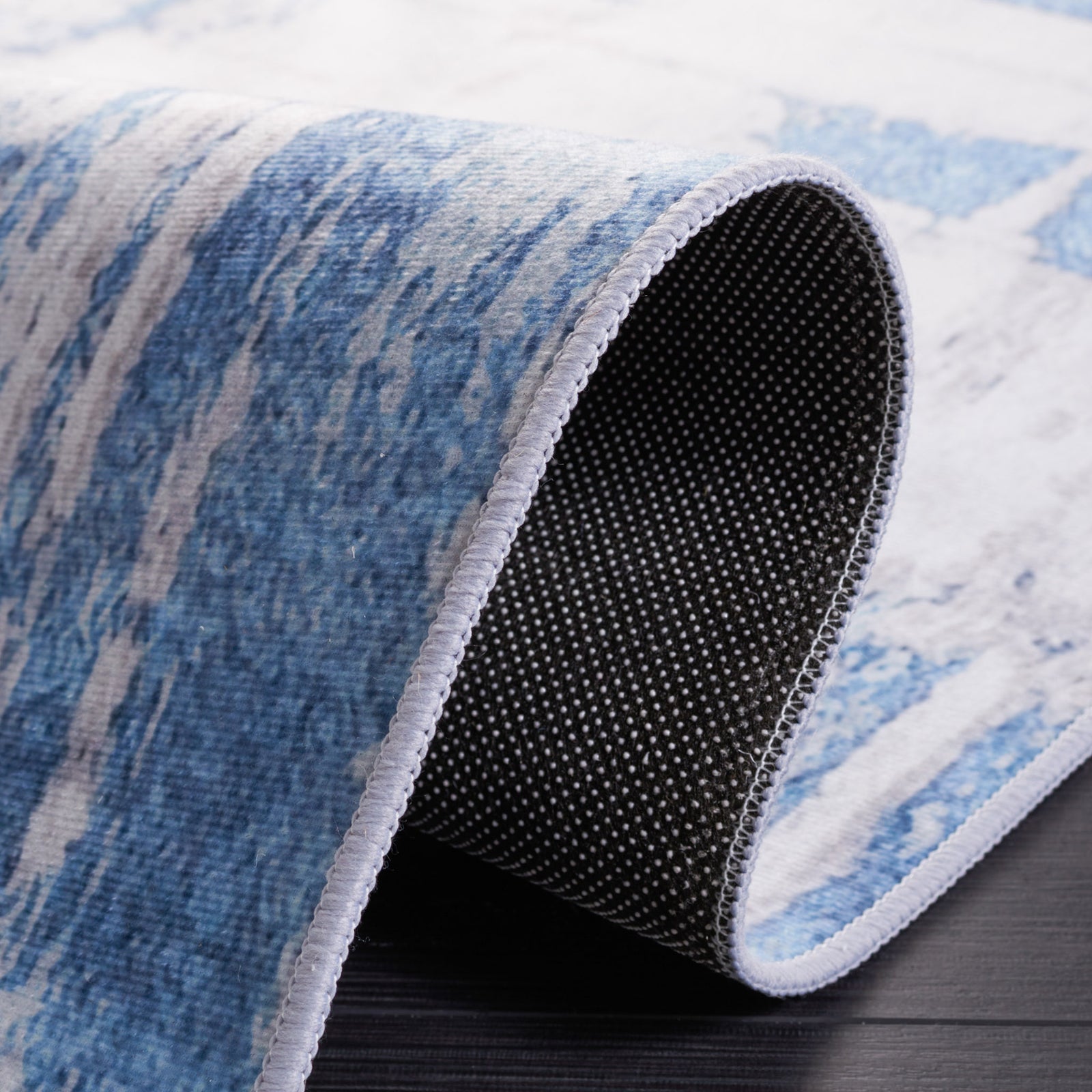Curled edge reveals the dotted, slip-resistant backing and clean serged finish. || TAC812F-5 || backing_studio