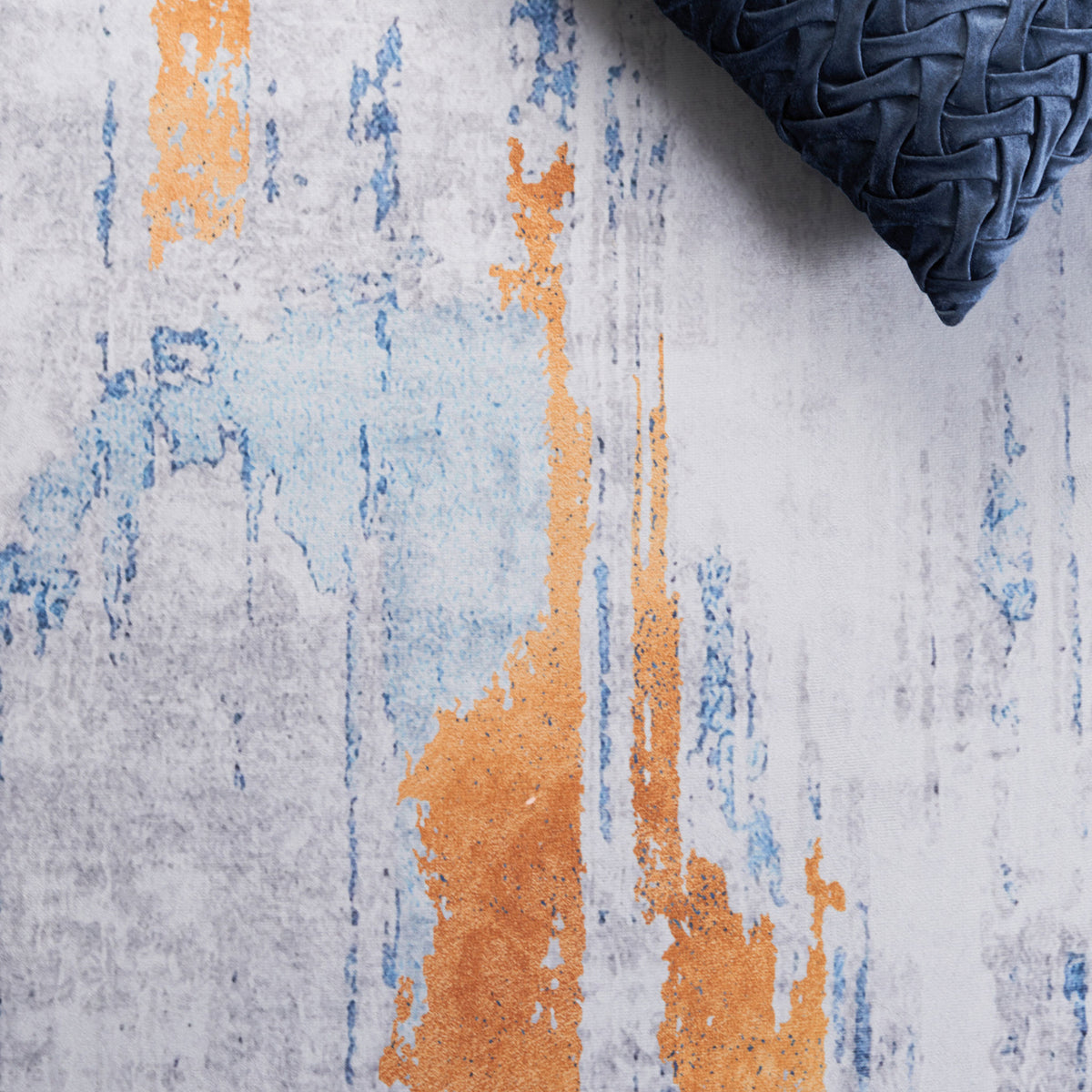 Velvety surface with painterly blue and orange accents brings modern vibrancy to the gray palette. || TAC812F-5 || detail_room