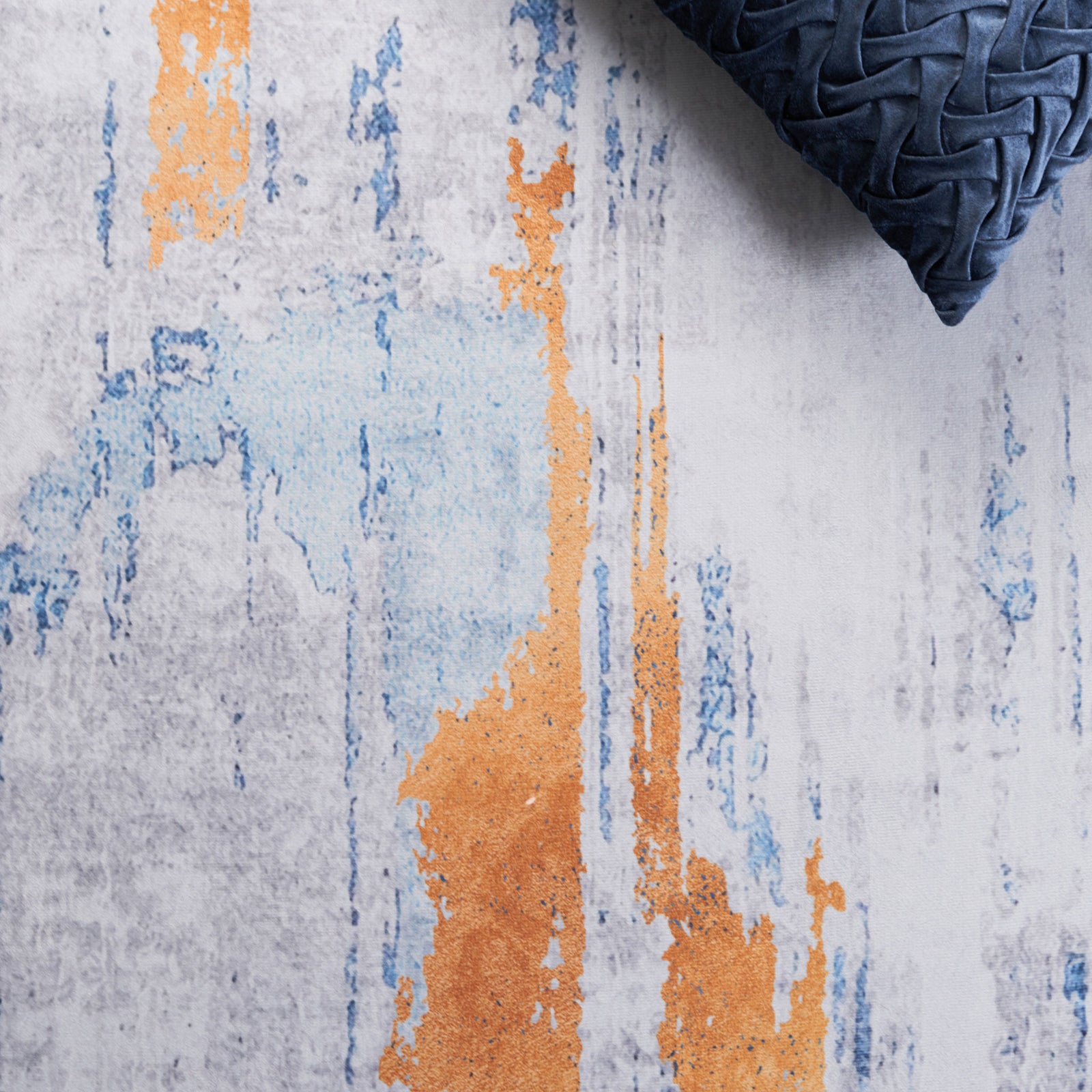 Velvety surface with painterly blue and orange accents brings modern vibrancy to the gray palette. || TAC812F-5 || detail_room
