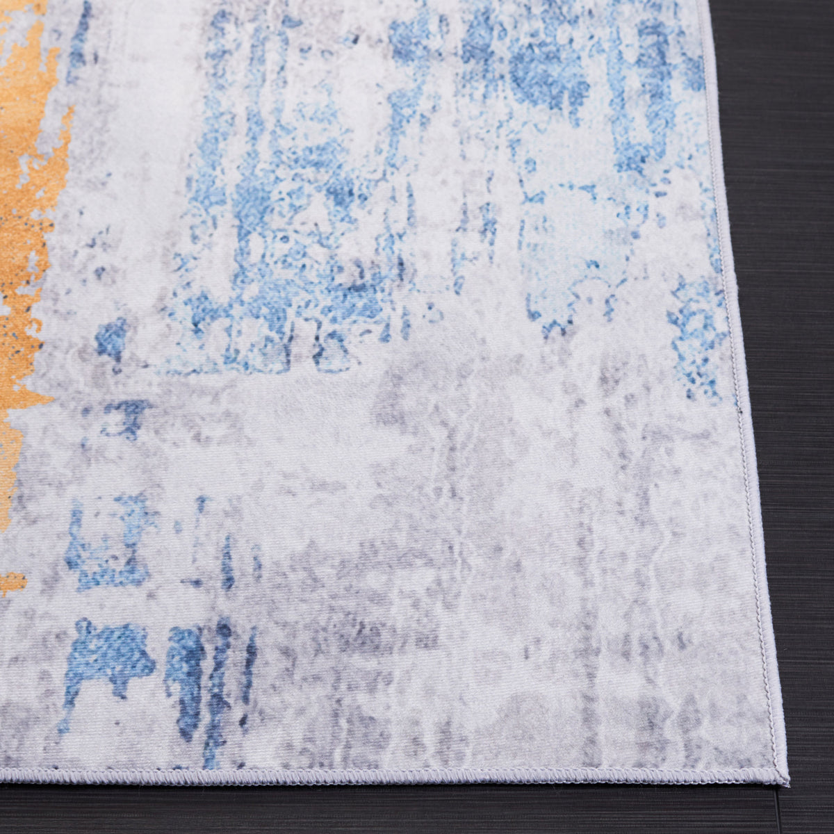 Serged corner highlights the soft feel and painterly gray, blue, and orange pattern. || TAC812F-5 || corner_studio
