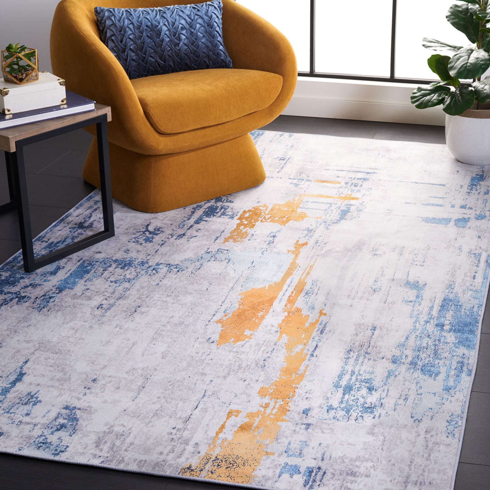 Modern abstract rug in gray and blue with warm orange accents anchors the room with vibrant energy. || TAC812F-5 || front_angle_room