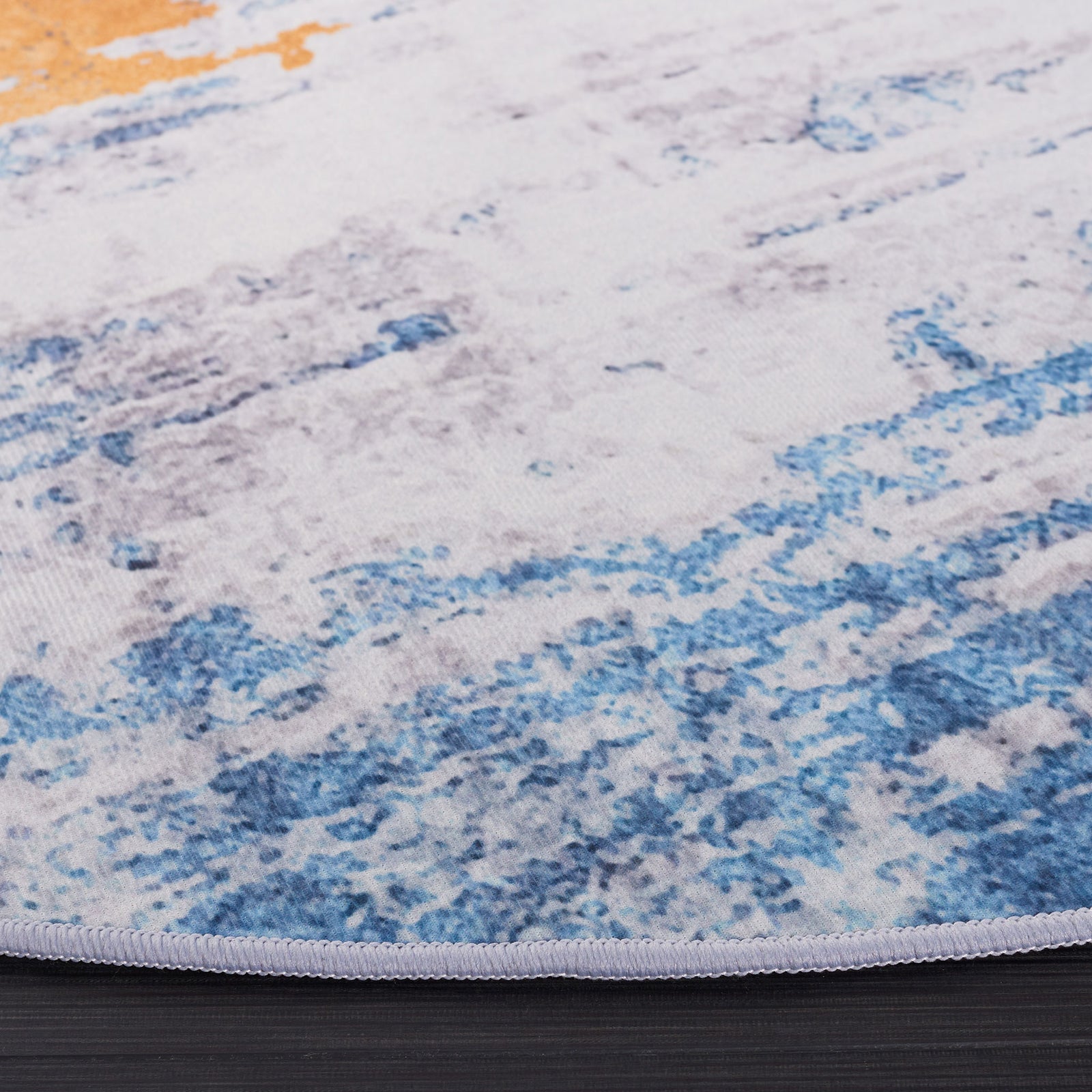 Abstract gray and blue round rug with gold accents, showcasing soft low pile and neatly serged edge || TAC812F-6R || detail_studio