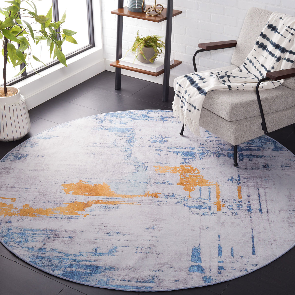Round rug in gray and blue with gold accents brings modern flair to a bright, cozy room || TAC812F-6R || top_angle_room