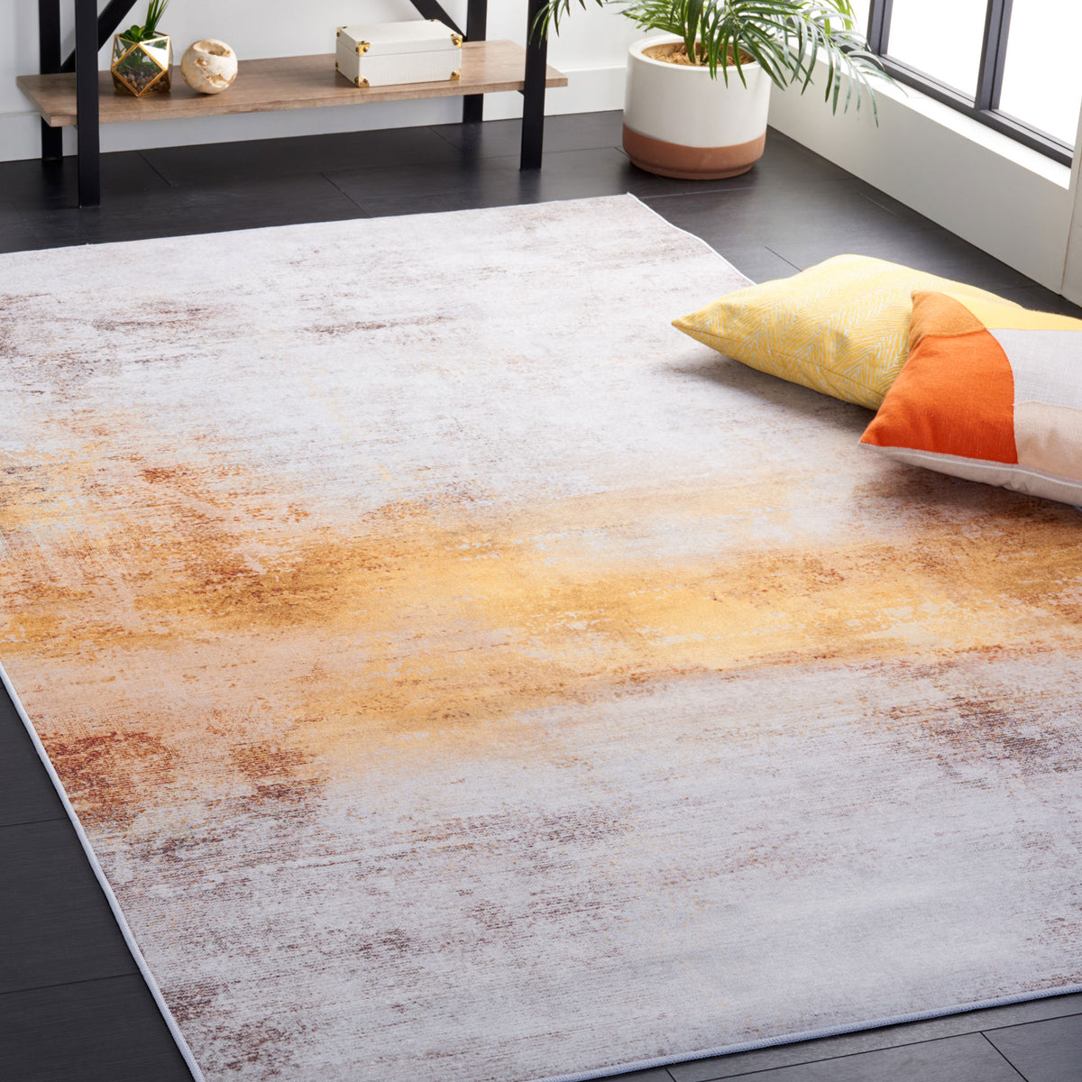 Warm rust tones sweep across a cool gray rug for a contemporary focal point || TAC813F-5 || front_angle_room