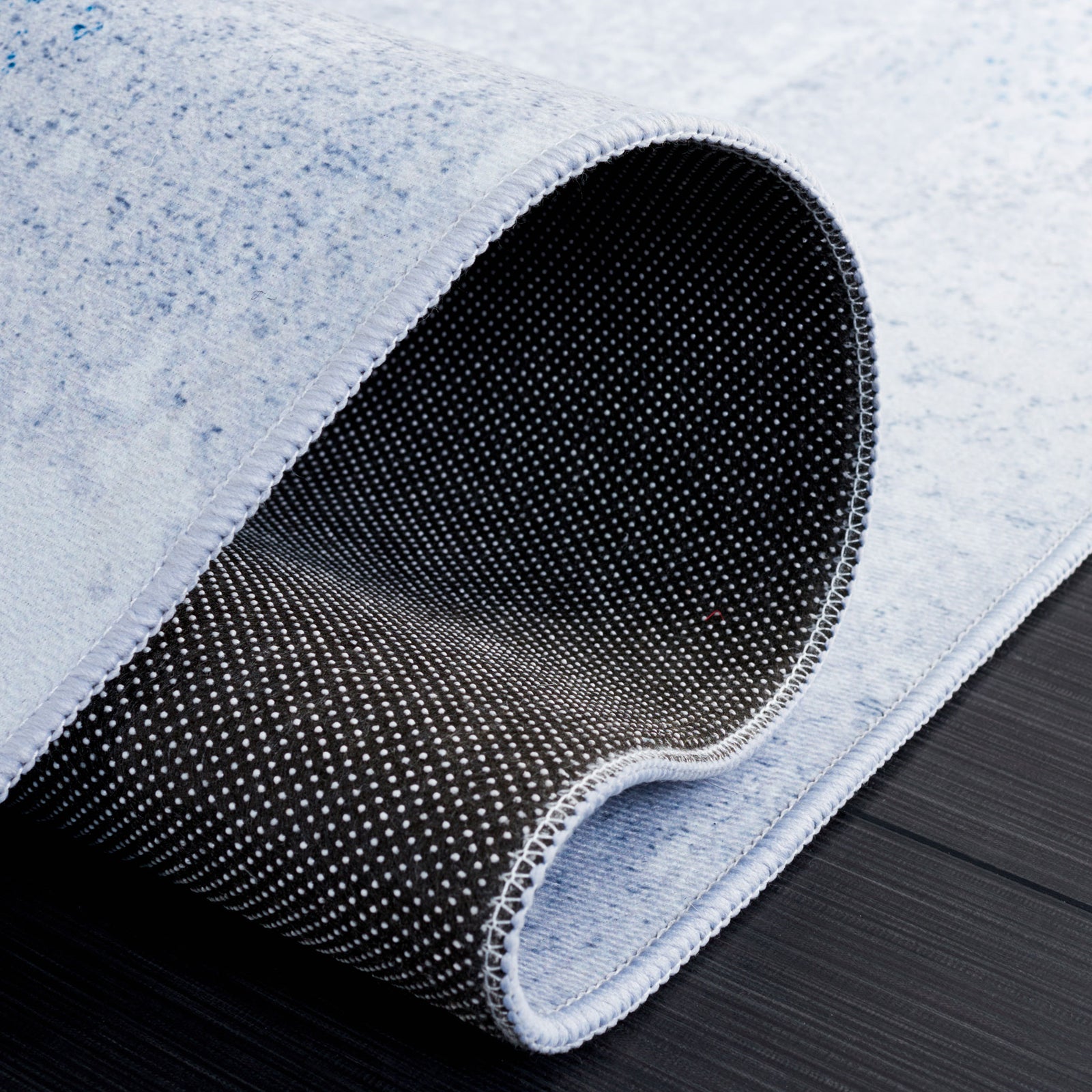 Non-slip dotted backing and flexible low pile designed for steady, easy living || TAC814F-5 || backing_studio