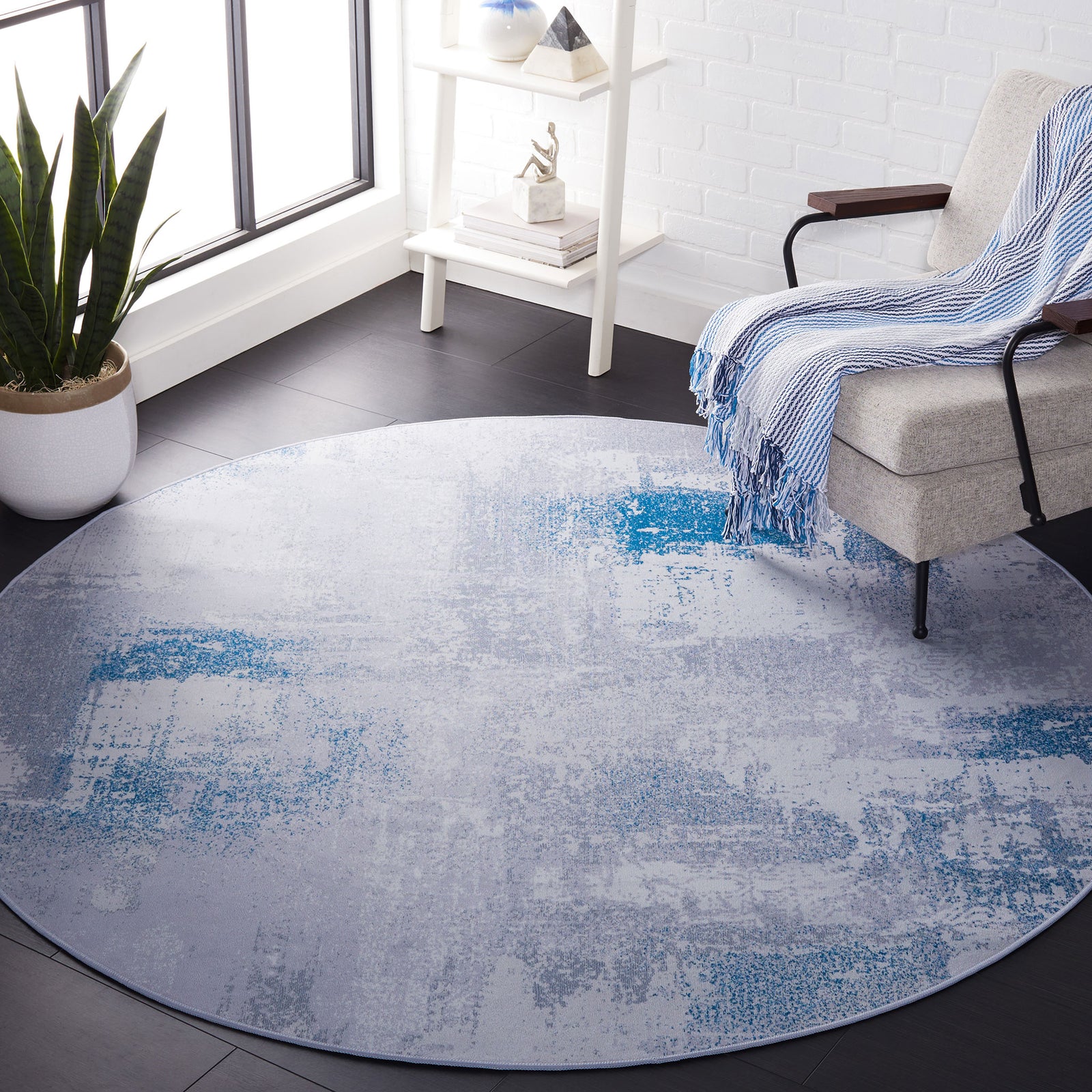 Round gray and blue abstract rug adding a calm, contemporary touch to a bright living space || TAC814F-6R || top_room