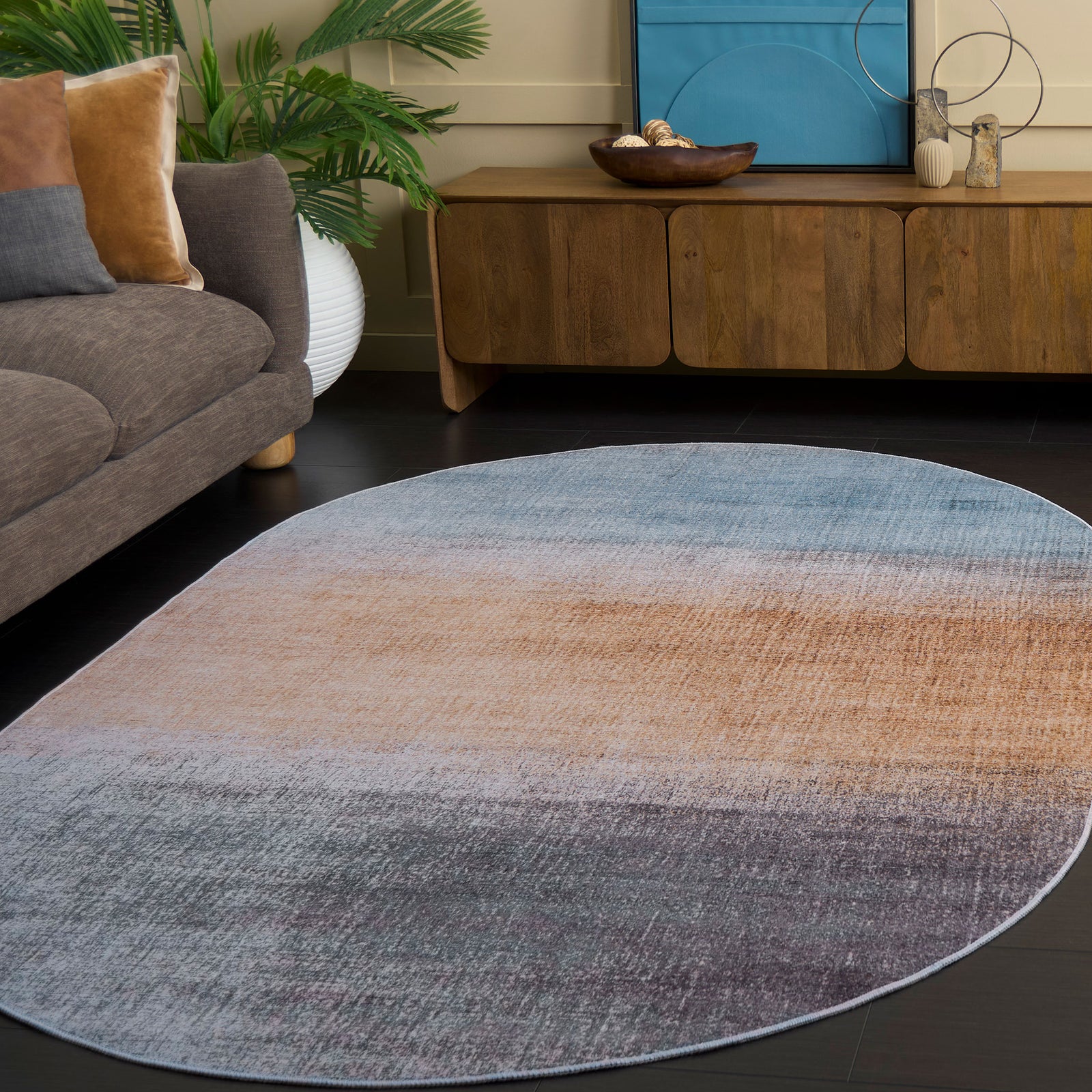 Stylish oval rug lends warm rust and cool gray-blue gradients that brighten modern decor. || TAC816F-5OV || front_angle_room