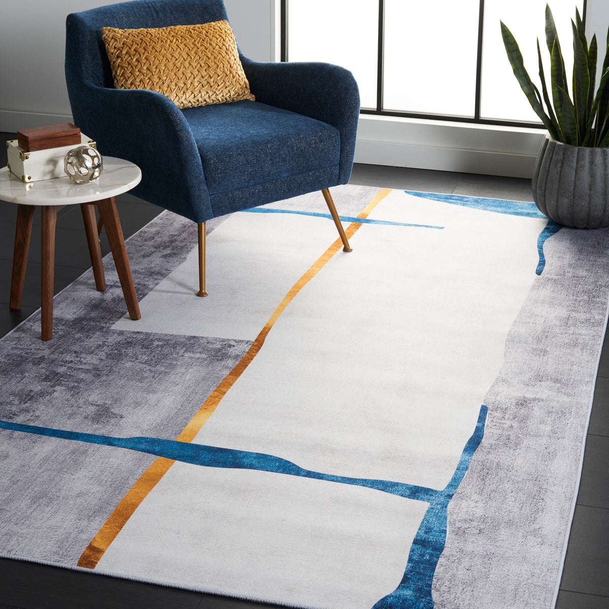 Modern abstract rug in gray with teal and gold lines brings bold color and easy-care comfort to living spaces || TAC820F-5 || front_angle_room