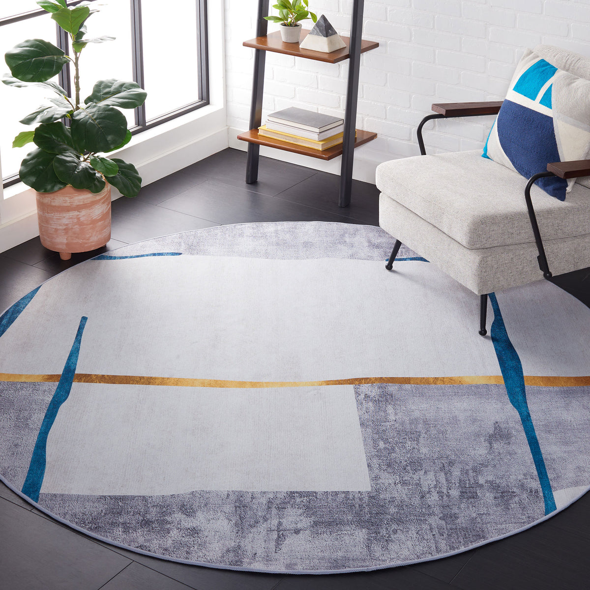 Modern round rug anchors the room with soft gray tones, teal streaks, and a sleek gold accent || TAC820F-6R || top_room