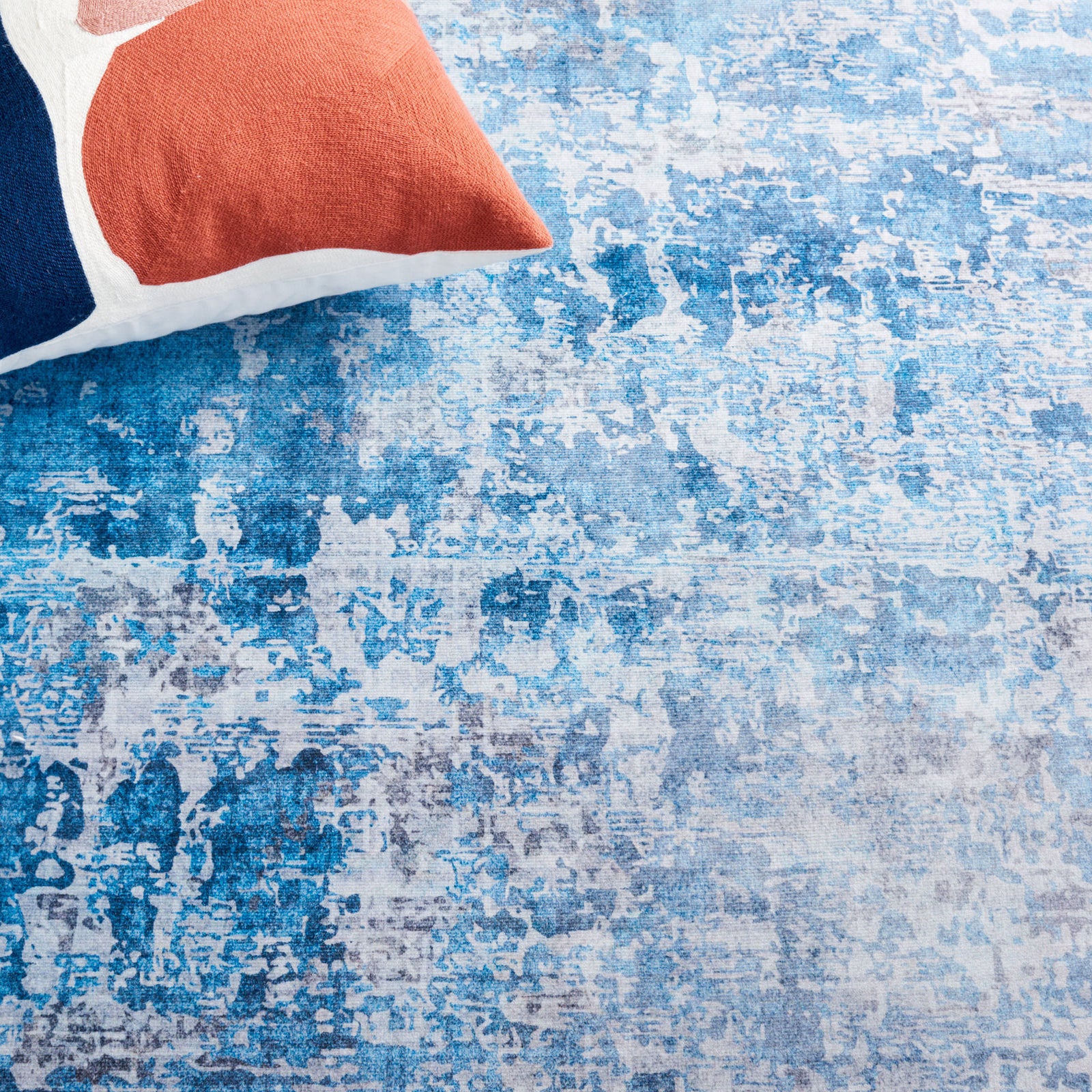 Vibrant blue and gray marbling brings a striking accent next to colorful pillows || TAC833F-5 || detail_room