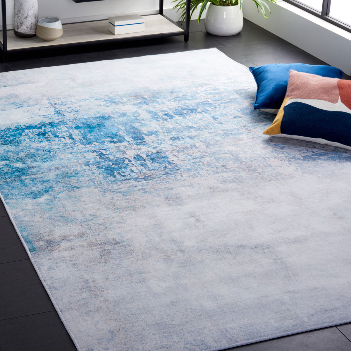Modern abstract rug in gray and blue brings a cool vibe to the room with a smooth, low-profile pile || TAC833F-5 || top_angle_room