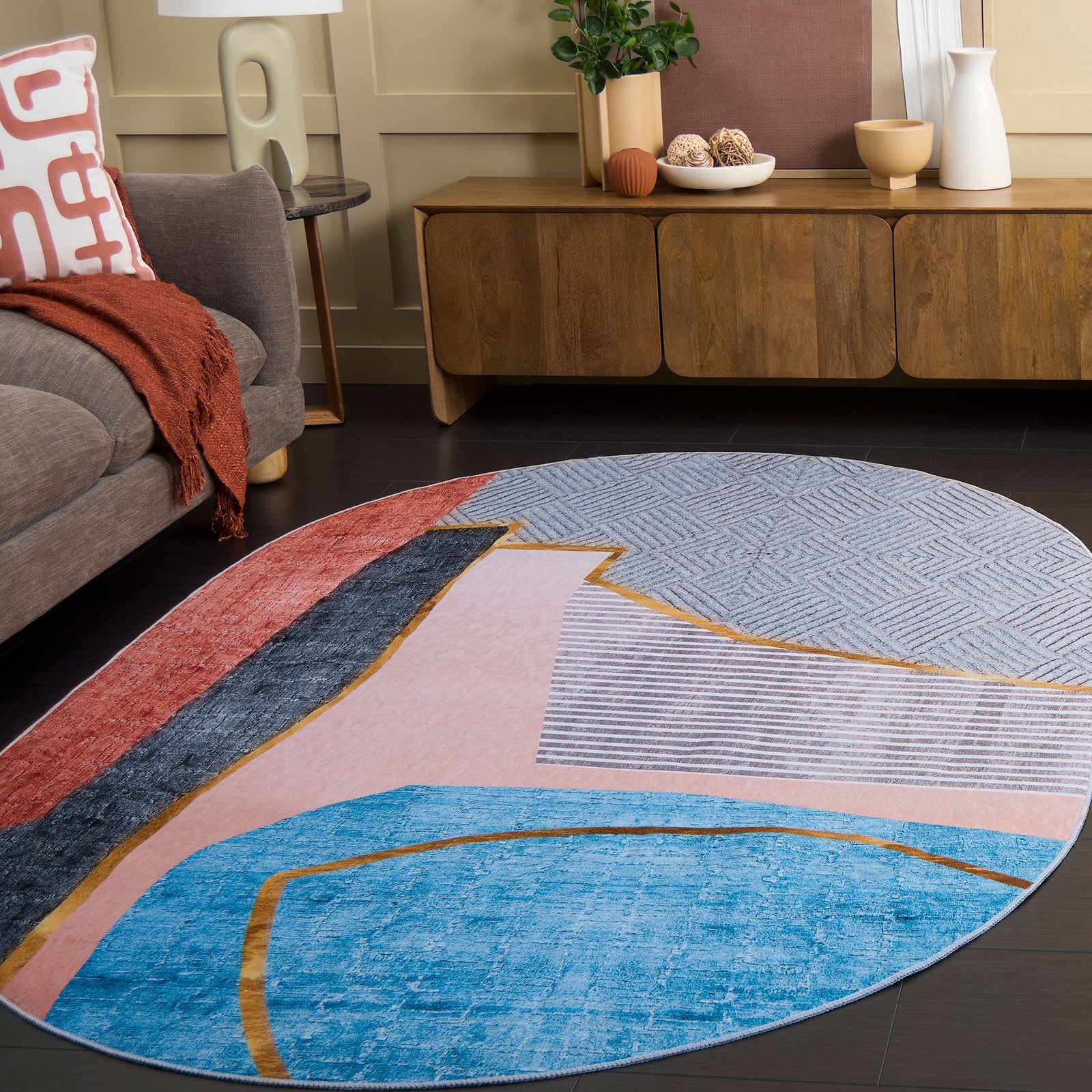 Contemporary oval rug anchors the space with soft pastels and striking gold-edged shapes || TAC834B-5OV || front_angle_room