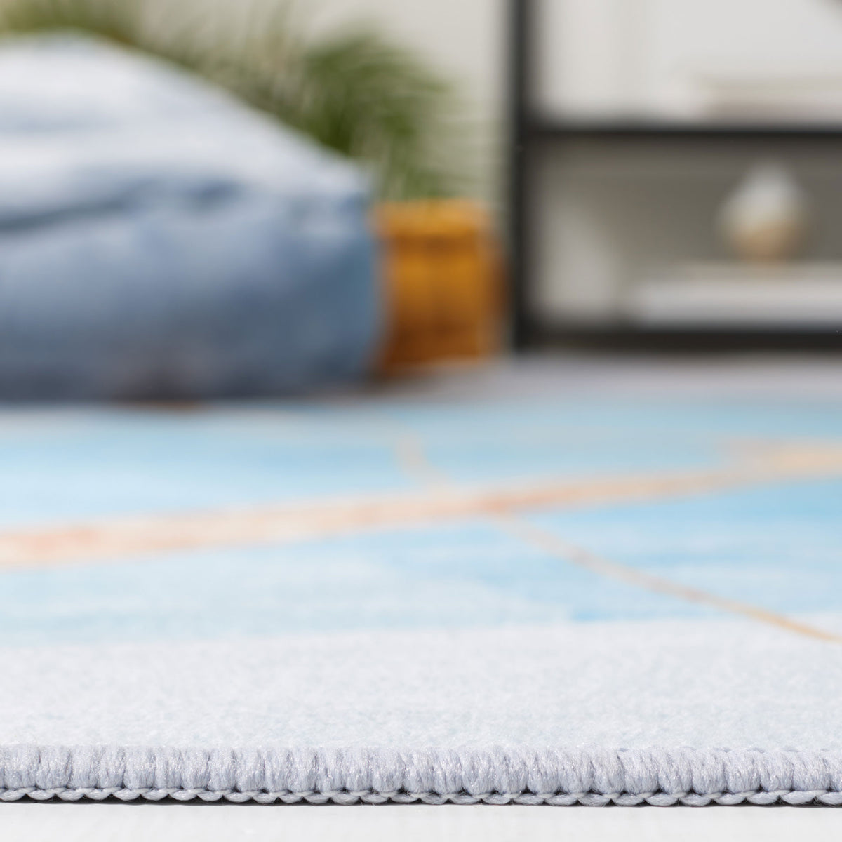 Low-profile rug with neatly surged edge and smooth surface in cool blues || TAC836M-5 || detail_room