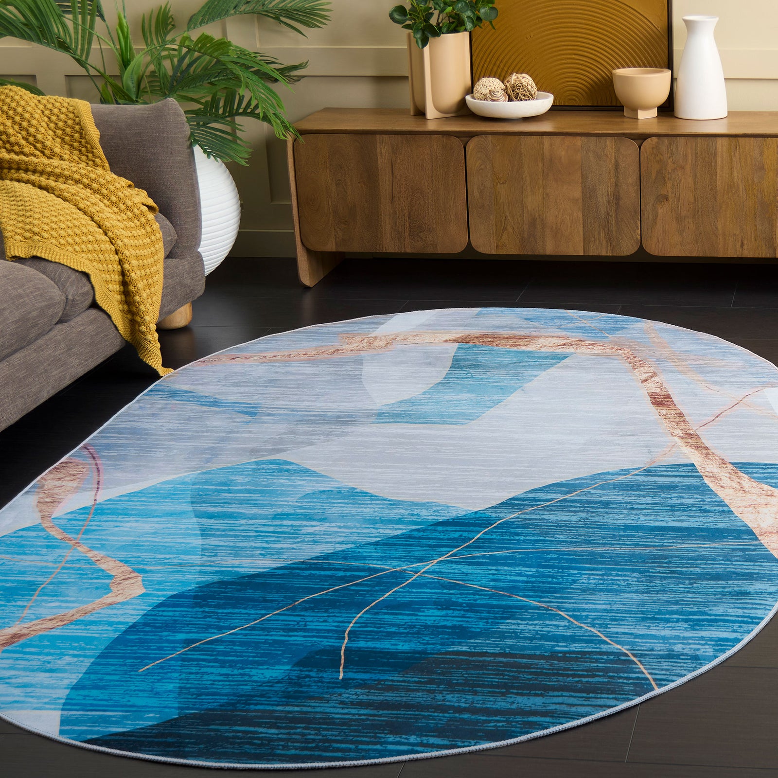 Oval rug blends cool blue tones with warm gold accents for a sleek, contemporary statement. || TAC836M-5OV || front_angle_room