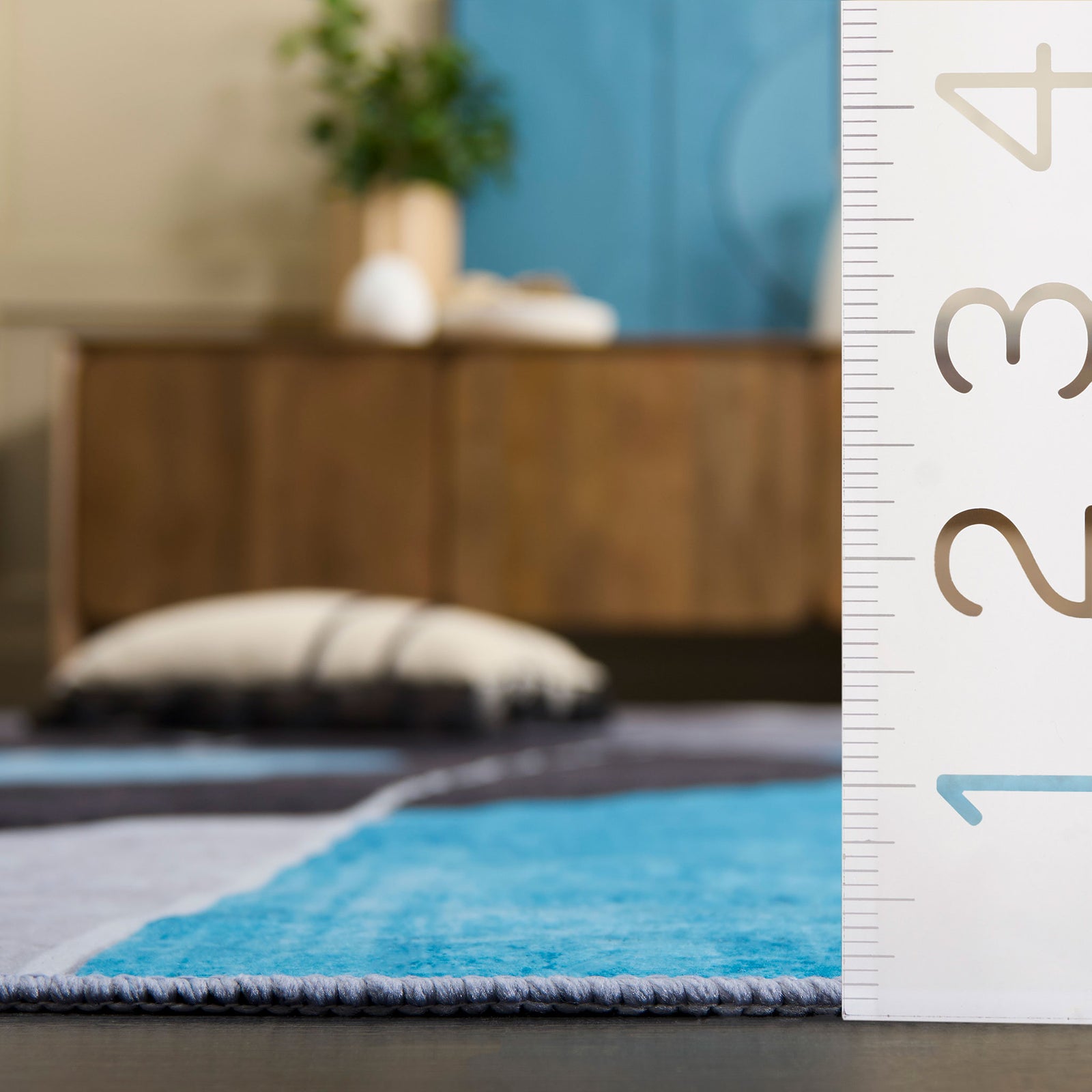 Low-pile thickness measured beside inch markings for easy reference. || TAC837G-5OV || dimension_room