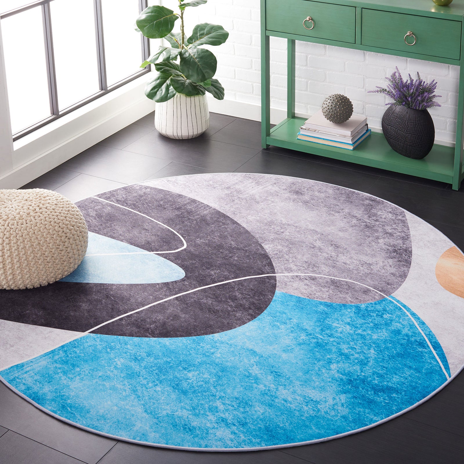 Round rug with abstract curves in gray, black, and turquoise complements modern decor. || TAC837G-6R || front_angle_room
