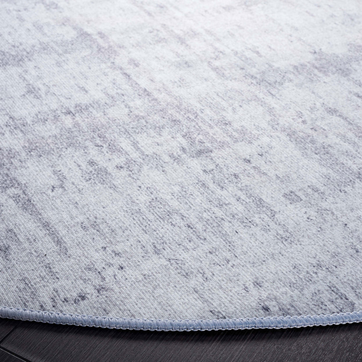 Heathered texture and neatly serged edge lend a refined finish to this low-profile round rug || TAC857F-6R || detail_room