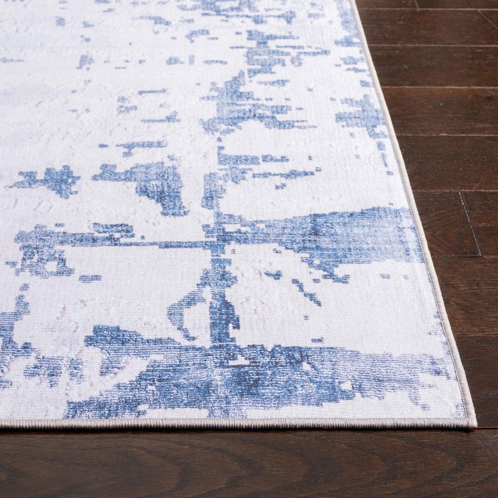 Abstract gray and navy rug with a washed, modern pattern and slim bound edges || TAC864F-5 || top_studio