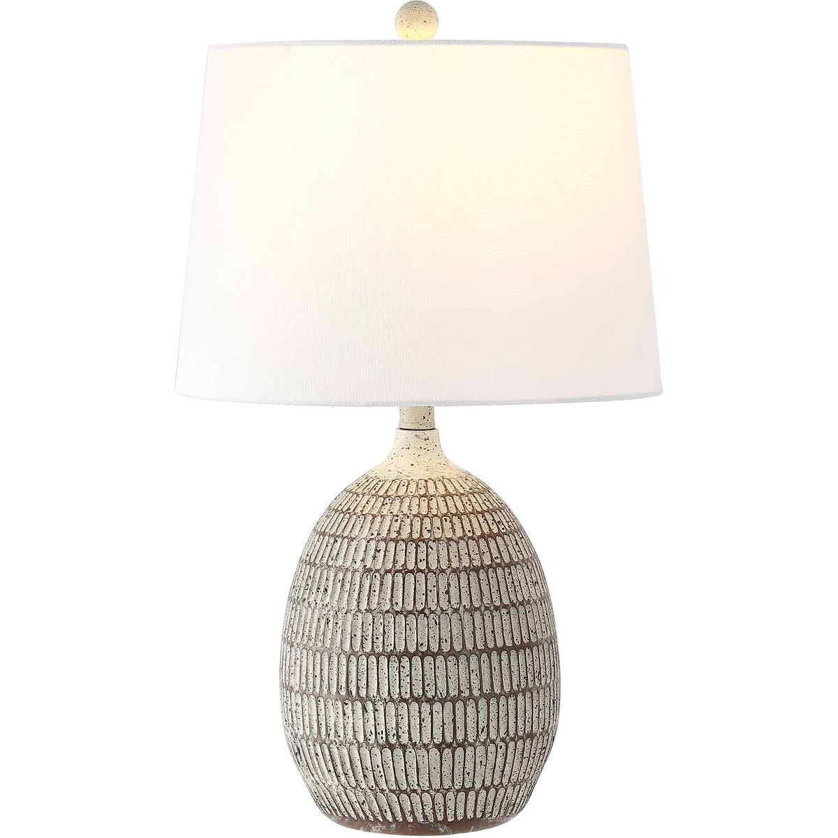 Warmly lit white shade crowns a patterned brown-and-white resin base with coordinating finial || TBL4421A || front_on_studio