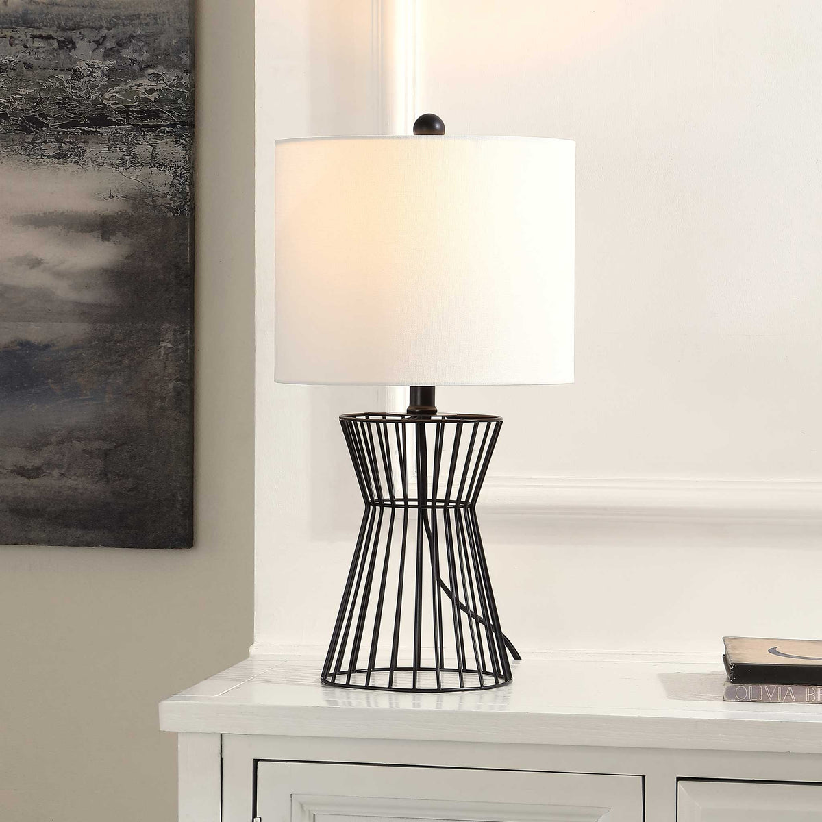 Warm, inviting glow from a black iron wire base topped with a soft white fabric shade || TBL4471A || front_angle_on_room