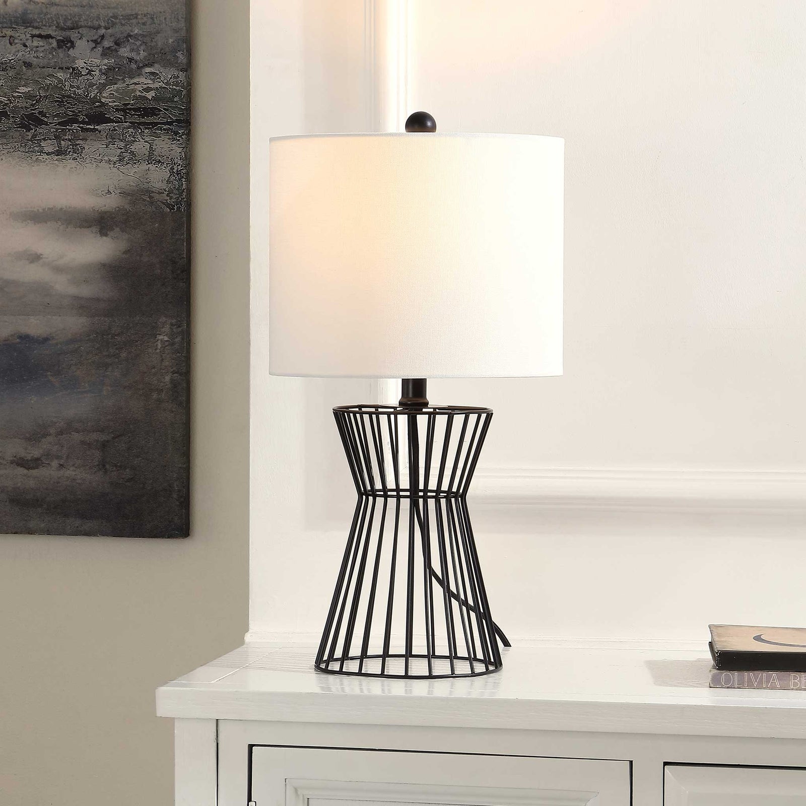 Warm, inviting glow from a black iron wire base topped with a soft white fabric shade || TBL4471A || front_angle_on_room