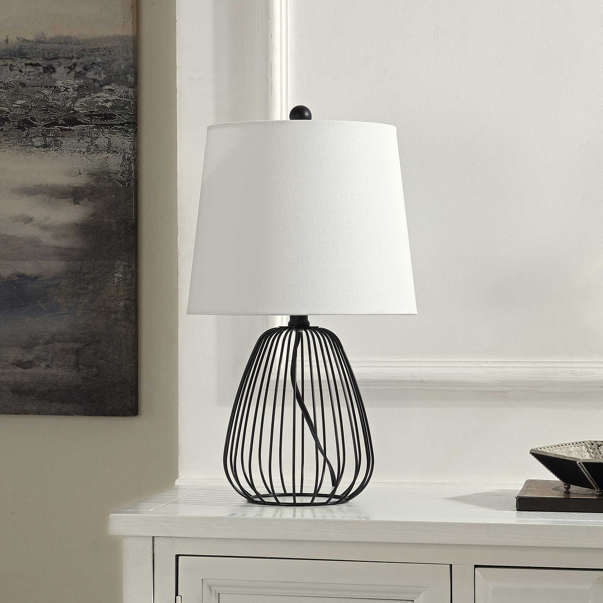 Minimalist black cage base and white fabric shade bring sleek industrial elegance. || TBL4472A || front_angle_room