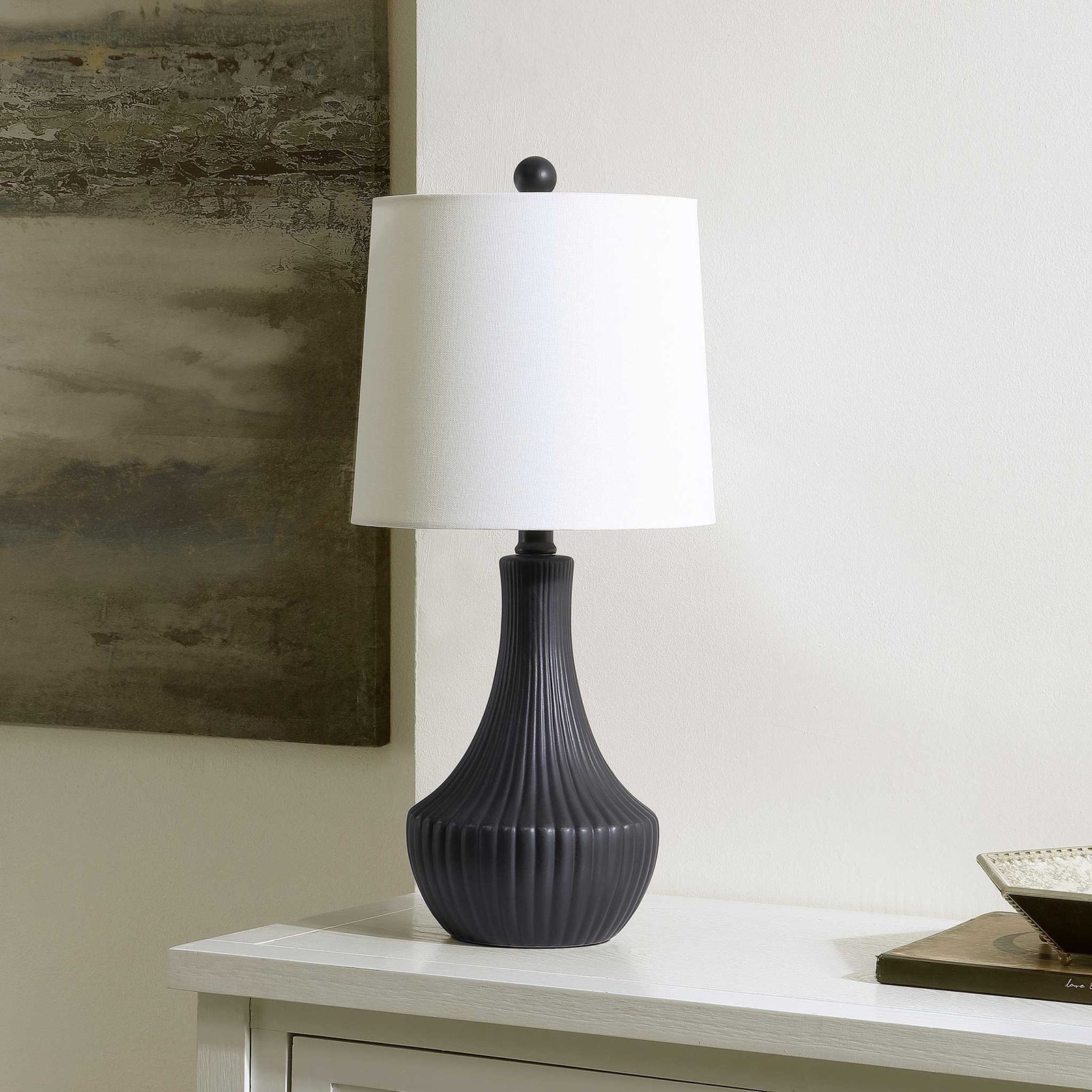 Sculpted black ceramic table lamp with ribbed texture and white fabric shade for modern warmth || TBL4479A || front_angle_room