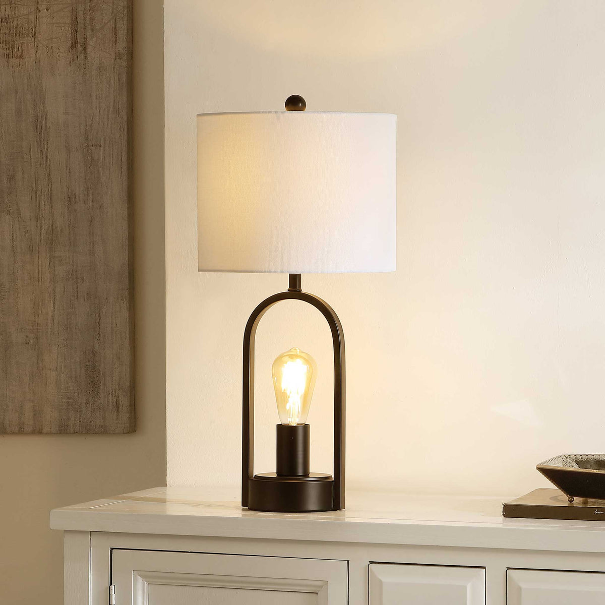 Warm glow highlights the black arch frame and soft white fabric shade || TBL4482A || front_angle_on_room