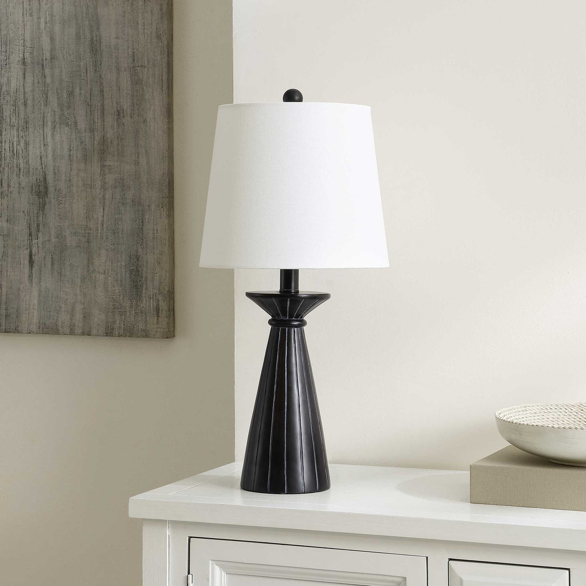 Matte black lamp brings clean lines and contrast with a tailored white shade for versatile decor. || TBL4485A || front_angle_room