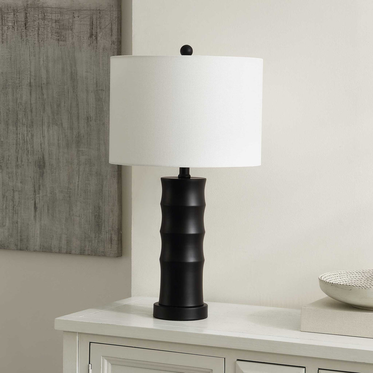 Sleek black iron lamp adds modern edge on a console, paired with a clean white shade || TBL4493A || front_angle_room