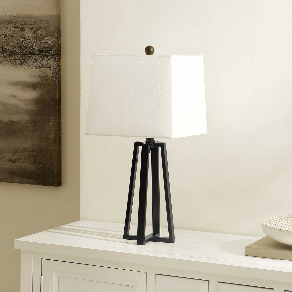 Sleek black iron lamp with a crisp white shade adds understated sophistication to consoles and sideboards. || TBL4505A || front_angle_room