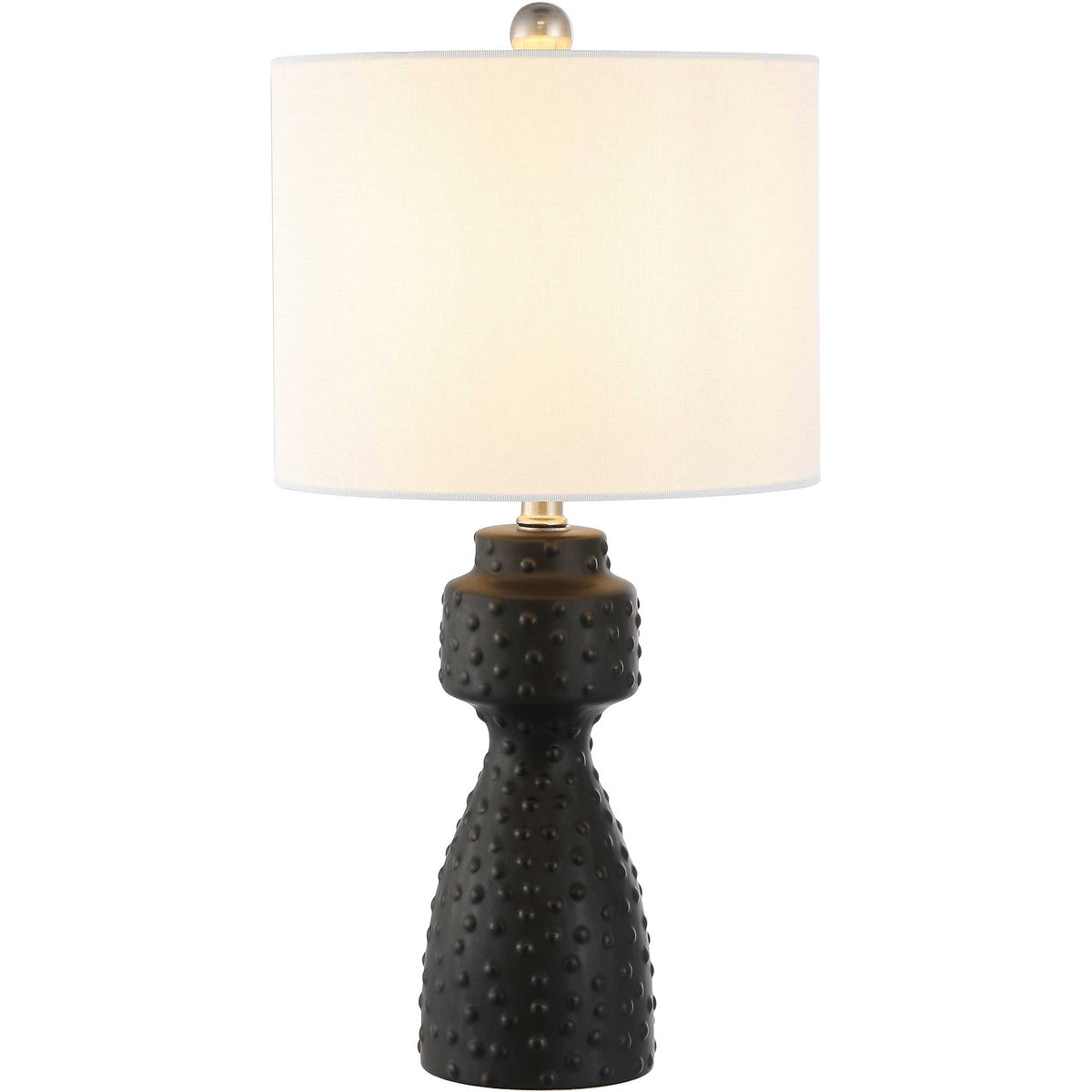 Warm glow highlights the dimpled black ceramic base beneath a crisp white drum shade || TBL4511A || front_on_studio