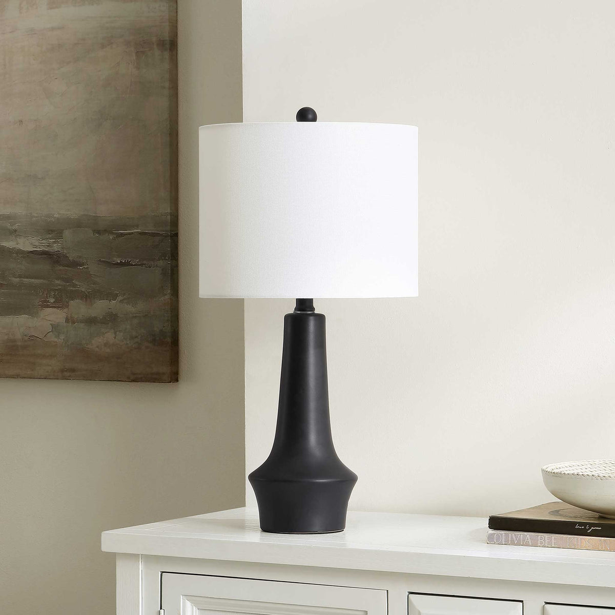 Modern black ceramic table lamp brings refined contrast with its white fabric shade. || TBL4514A || front_angle_room