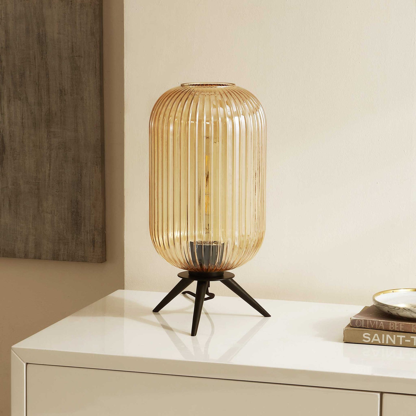 Textured amber glass shade pairs with a minimalist black base for effortless modern style. || TBL4528A || front_angle_room